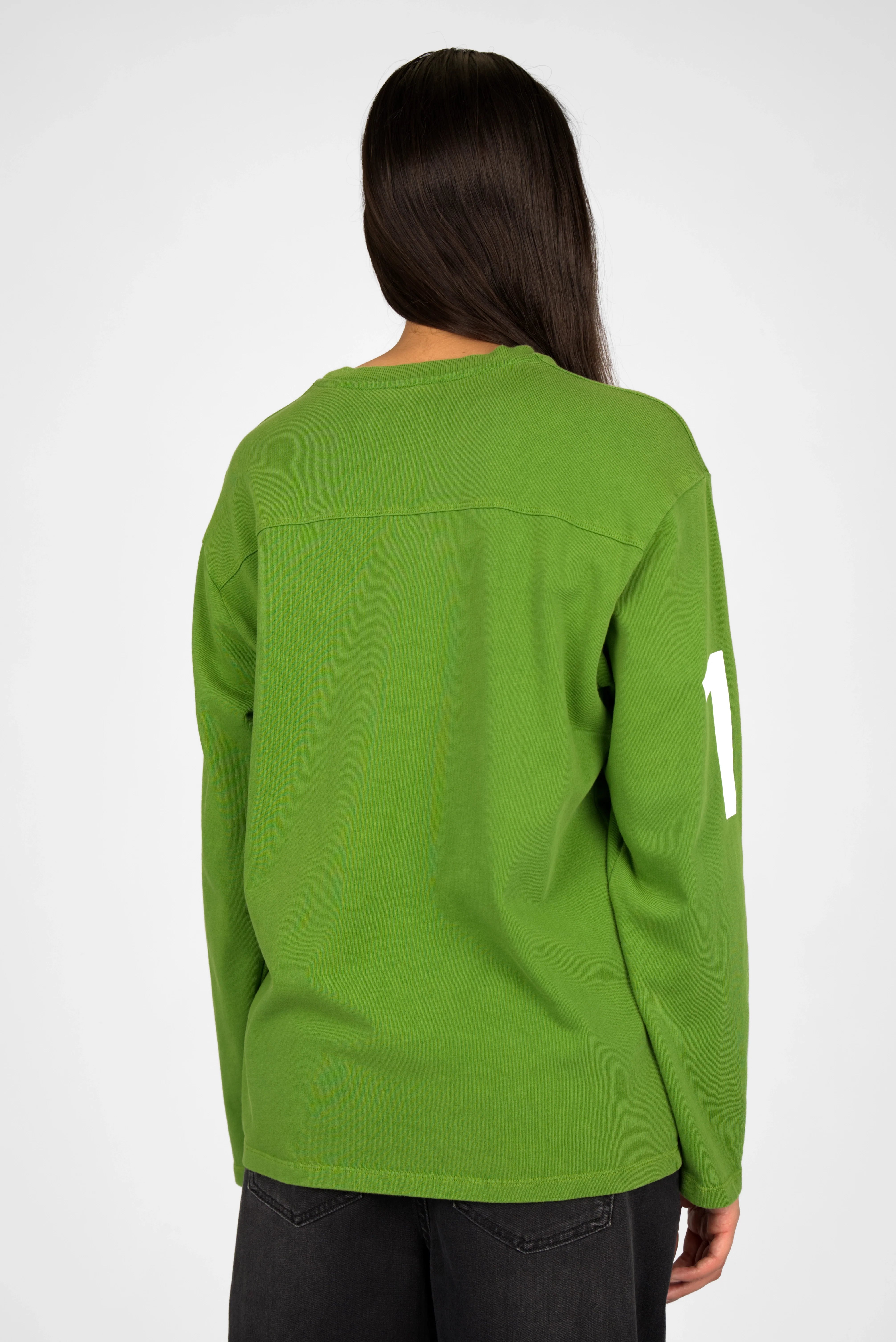 Back view of a green AGA Statement Sweater with a white number print on the sleeve.