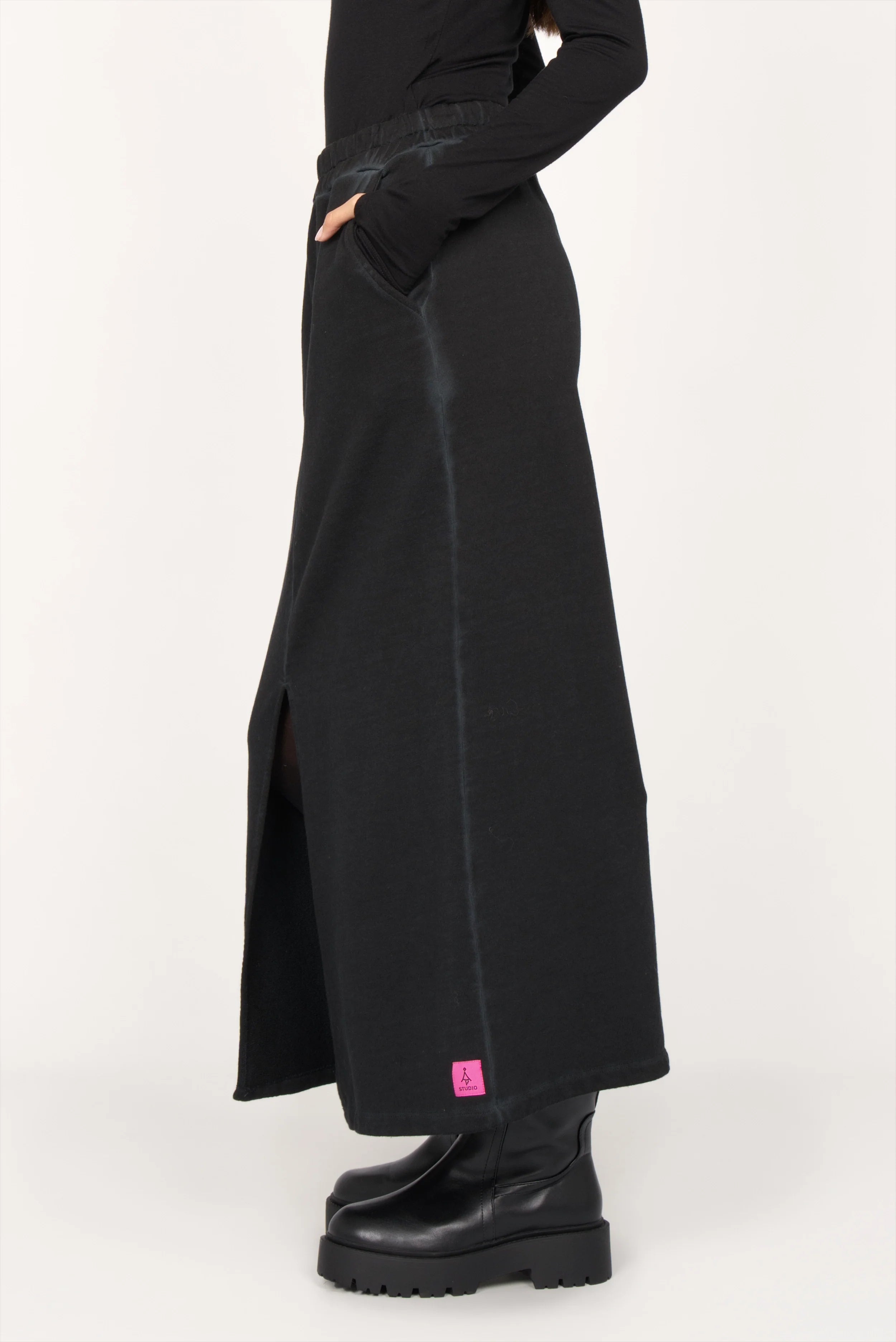 ALEMENE Studio Sweatrock black midi skirt with elastic waistband, front slit, side pockets, and pink logo patch
