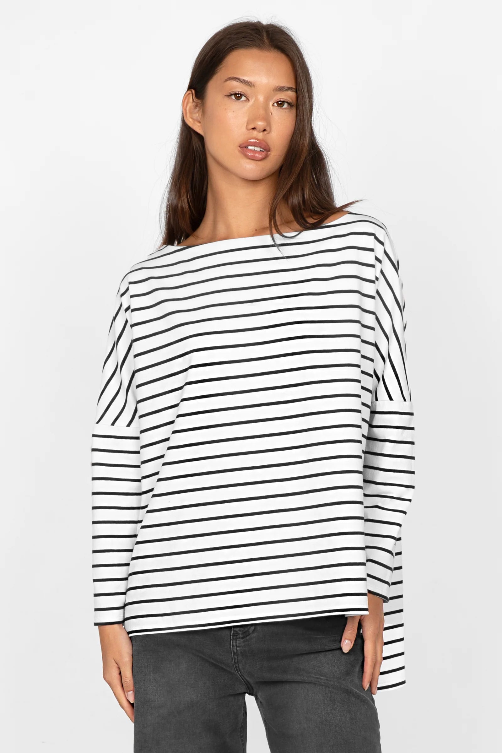 Woman wearing AMALEA striped black and white cotton stretch long sleeve top with boat neckline and relaxed fit