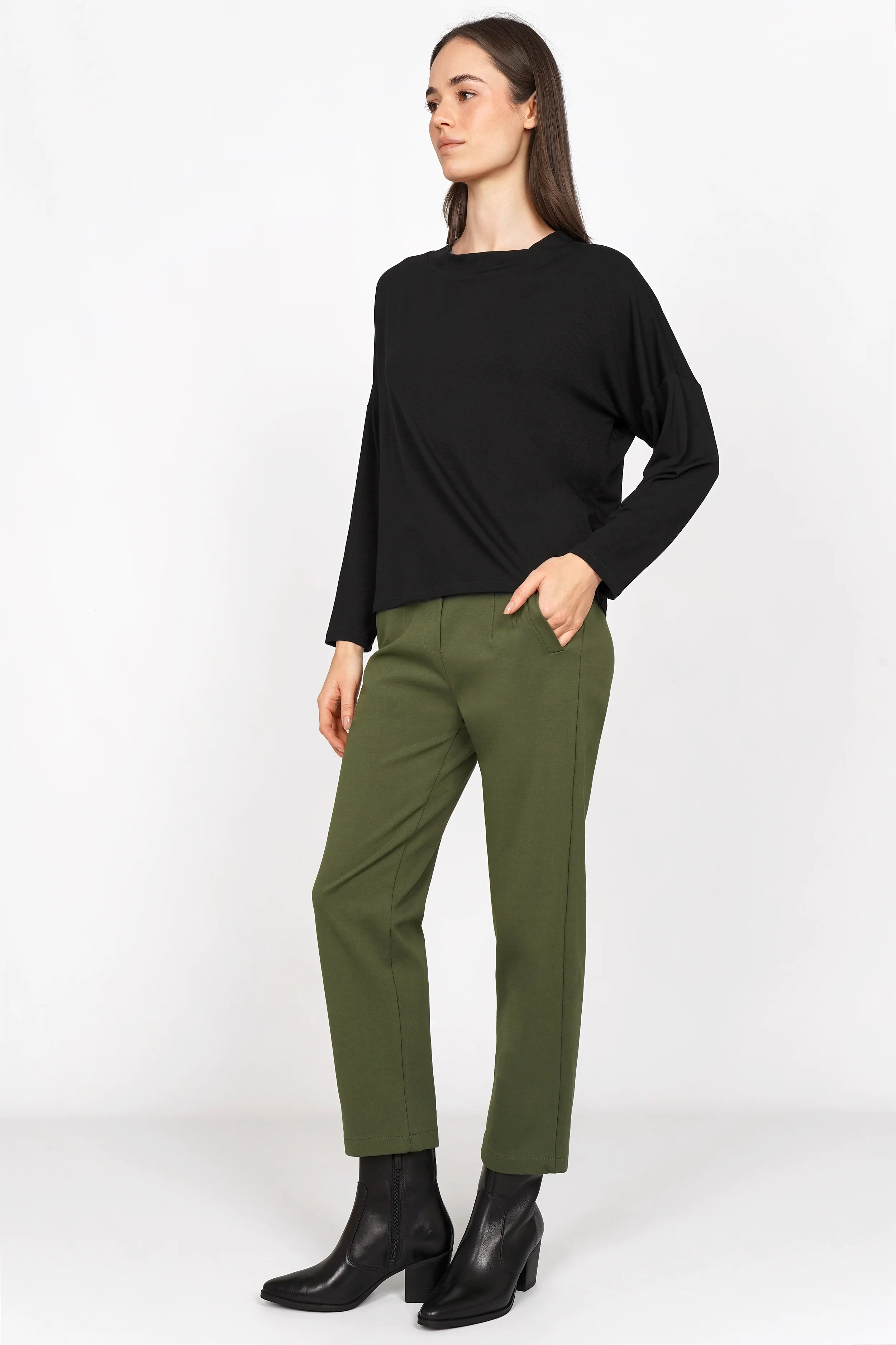 Woman wearing olive green CEELIA high waist ankle pants with a slim fit and black top
