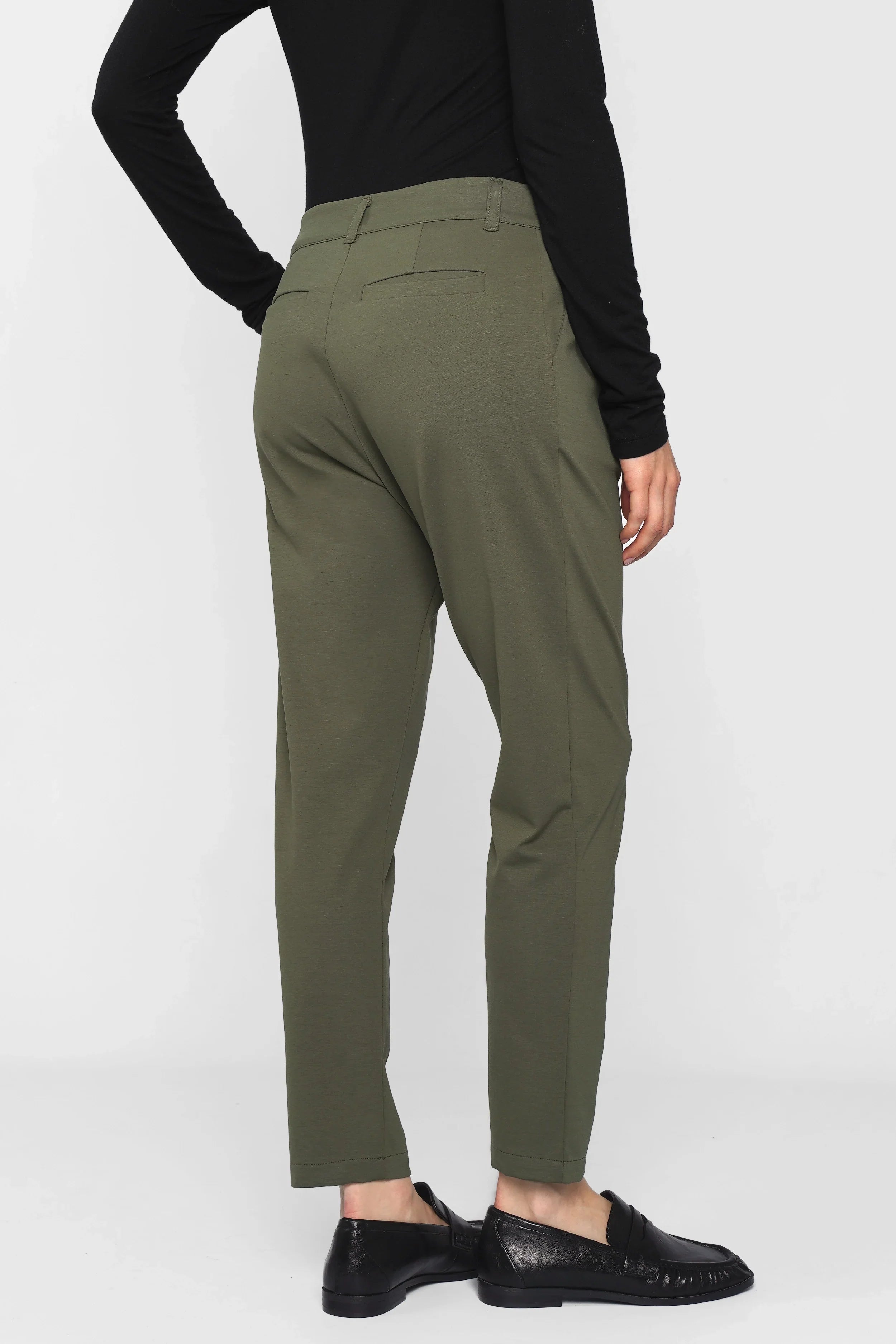 Back view of olive green HEELENA Tapered Pants with relaxed fit and tapered leg worn by model