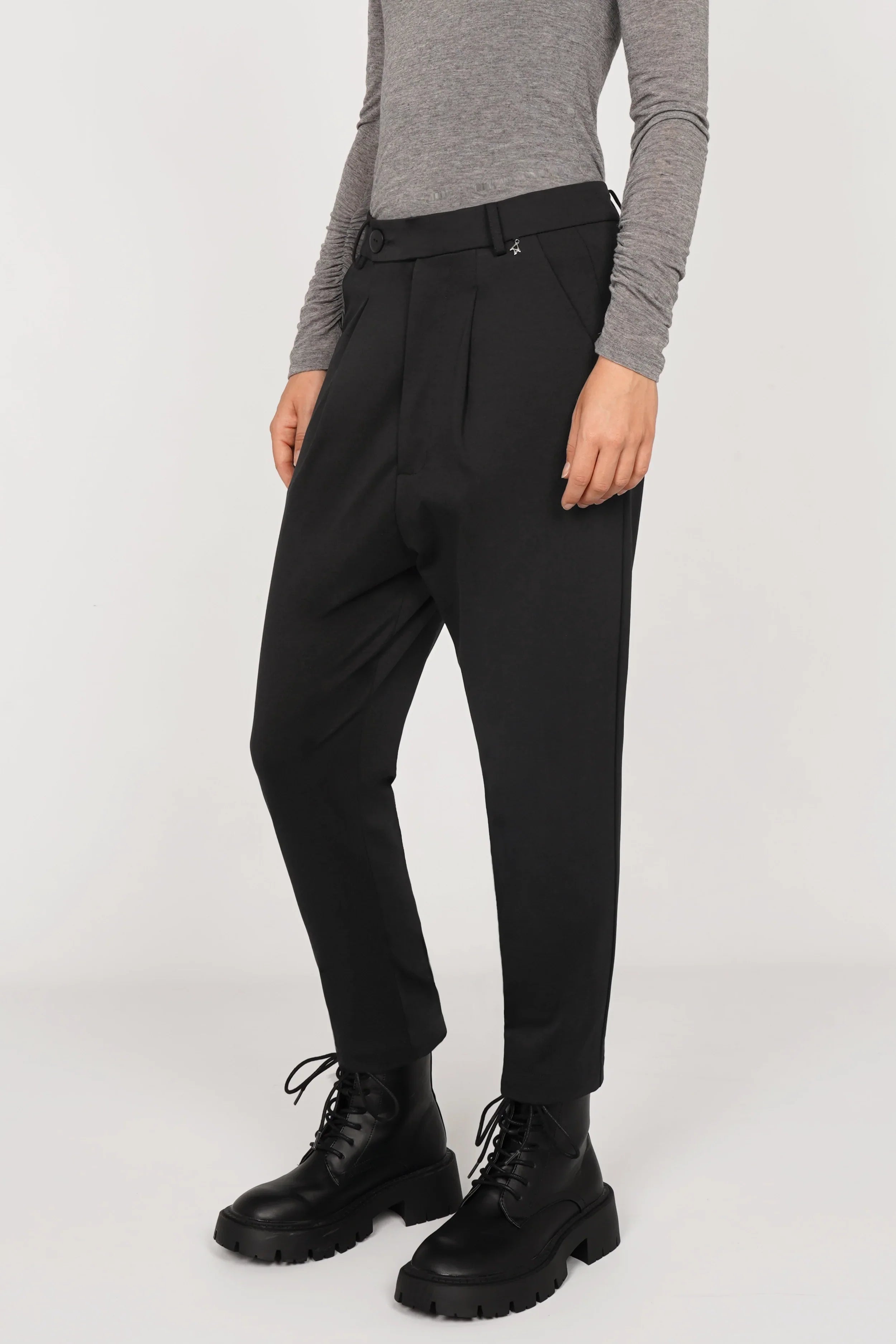 Black JALDI cropped tapered pants with elastic waistband and subtle pleats worn with gray top and black boots