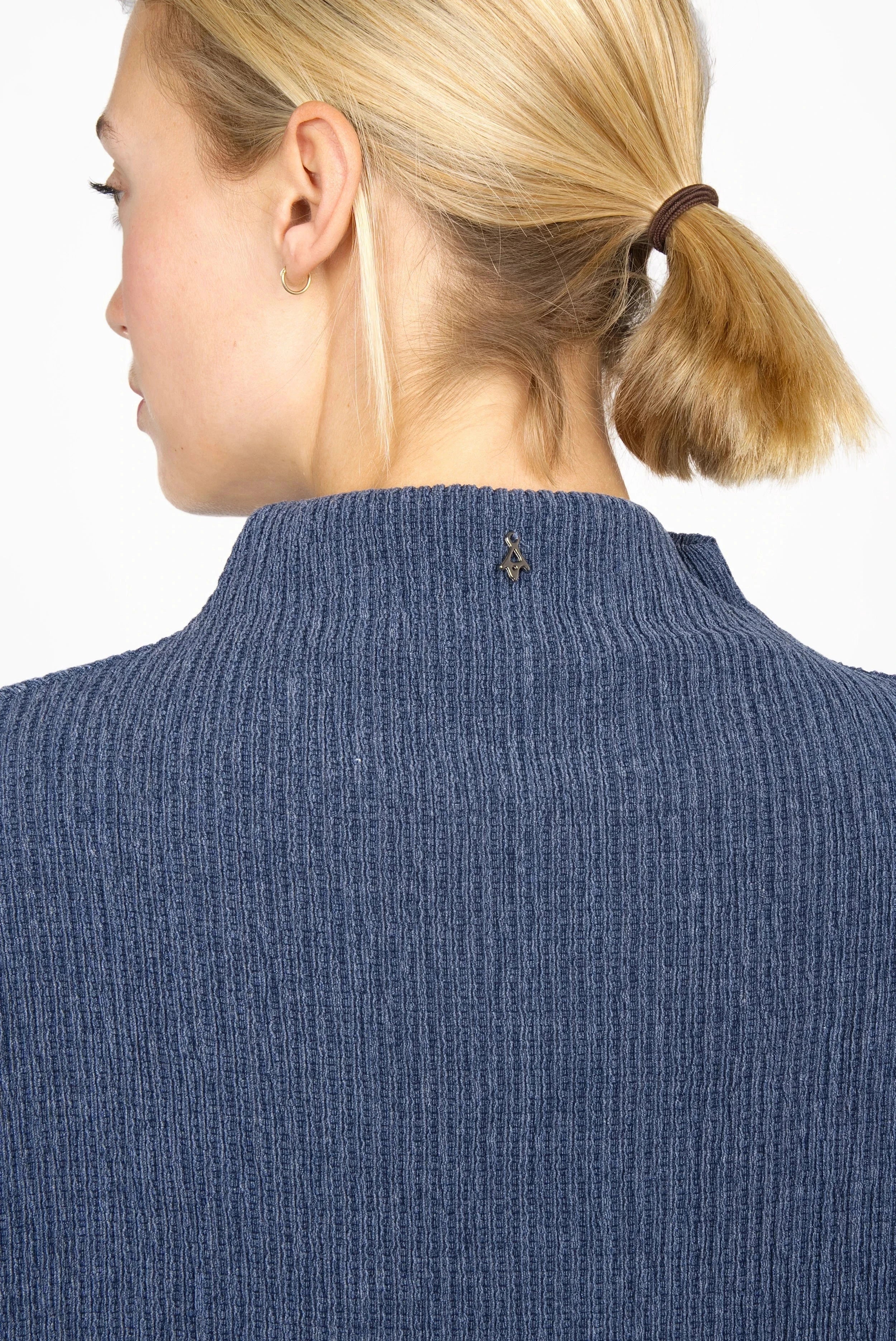 Back view of woman wearing blue NORELI Longsleeve with mock neck and pleated crepe jersey fabric