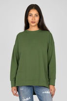 Green EIREL oversize sweater with round neckline, dropped shoulders, ribbed cuffs, tonal logo embroidery, and relaxed A-line silhouette.