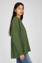 Green EIREL oversized sweater with relaxed silhouette and dropped shoulders, featuring round neckline and tonal logo embroidery.