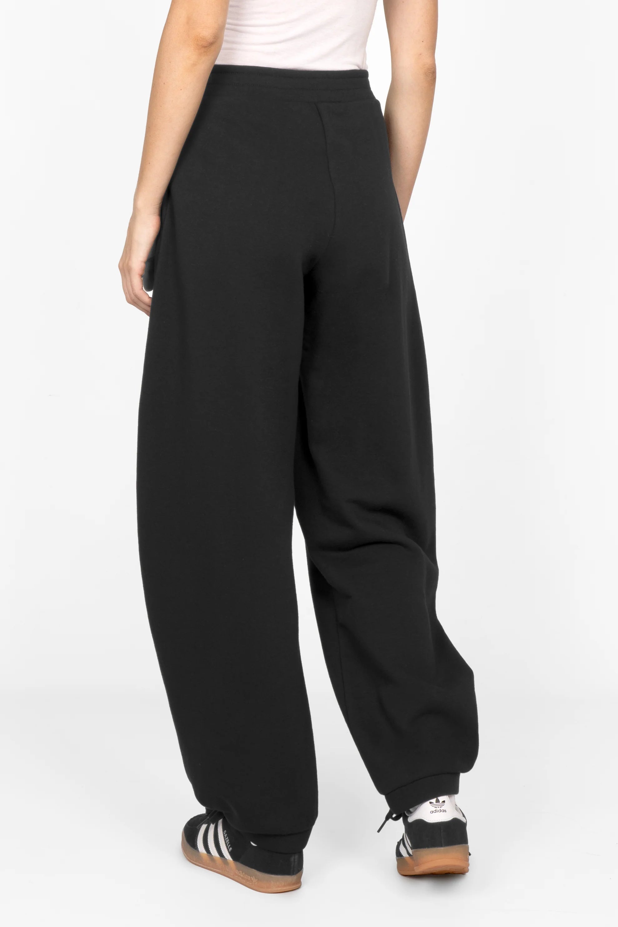 Black ELVEA O-Shape relaxed fit sweathose with elastic waistband and tapered cuffs shown from back