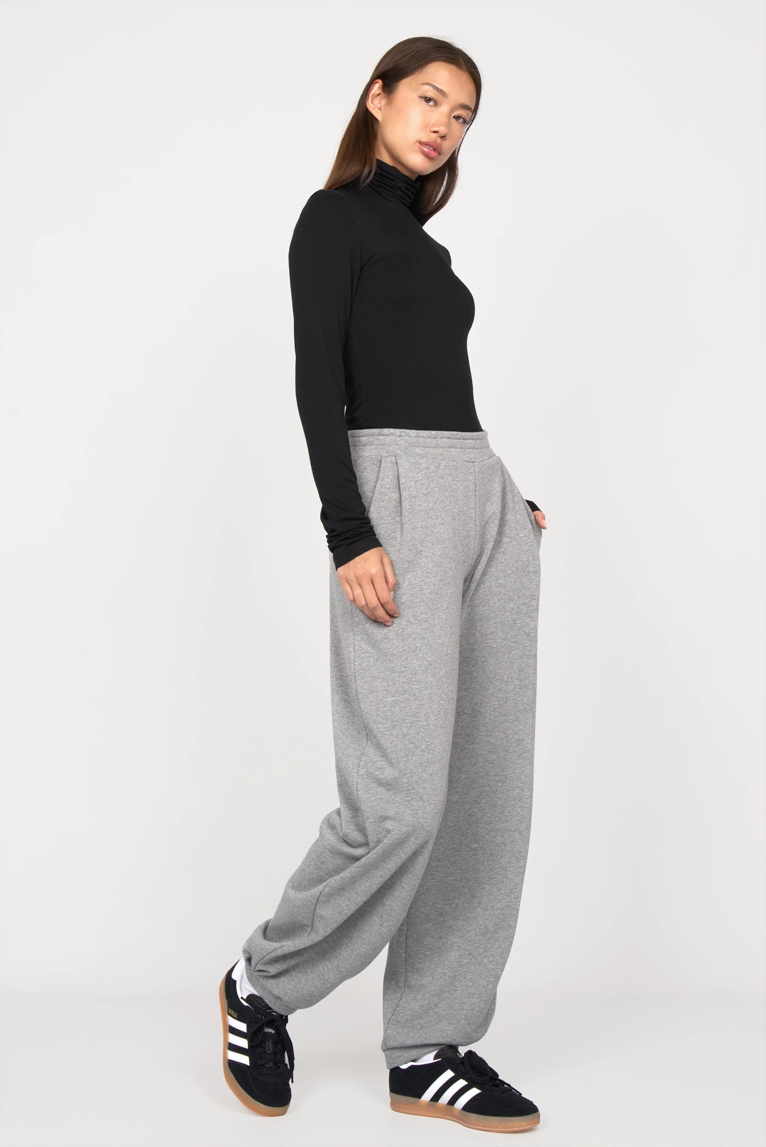 Woman wearing ELVEA O-Shape Sweathose relaxed fit grey sweatpants with elastic waistband and side pockets