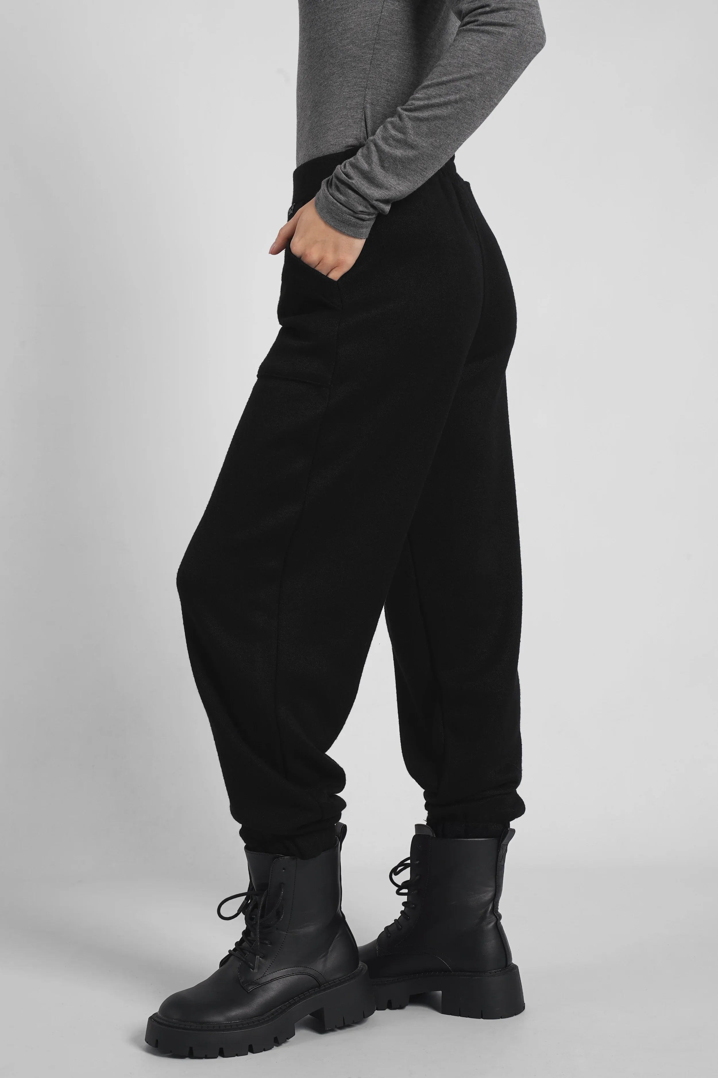 Black FRELA Jogpant in soft fine knit with elastic waistband and ribbed cuffs, relaxed fit model.