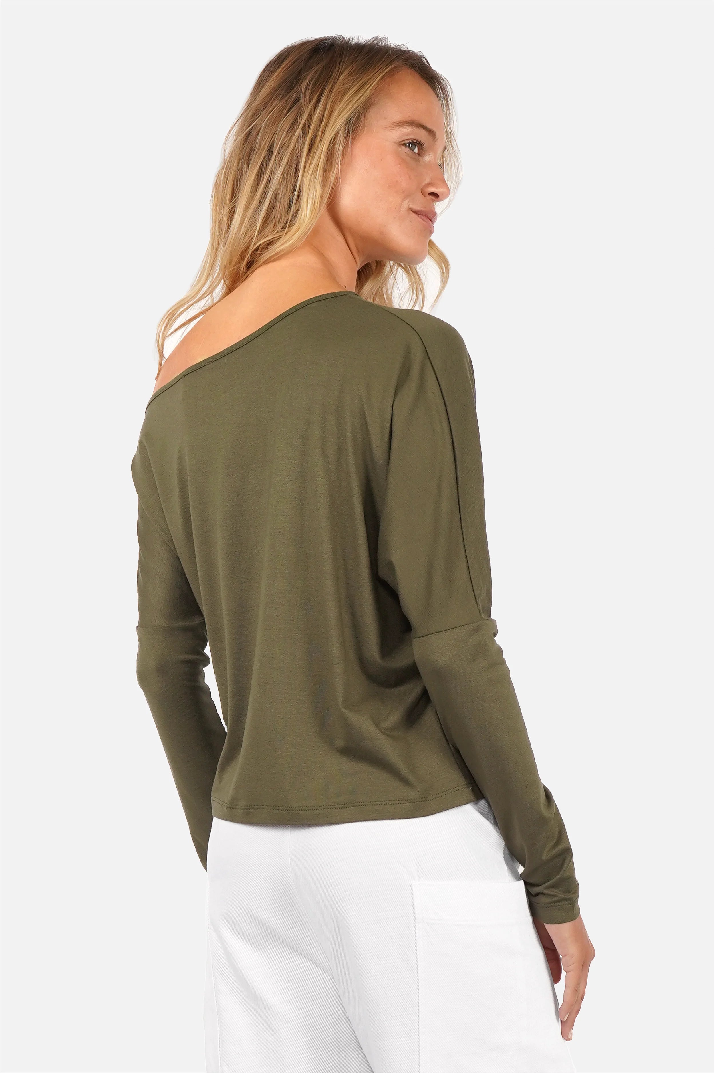 Model wearing FRYA one shoulder longsleeve with asymmetrical neckline and batwing sleeves in lightweight viscose