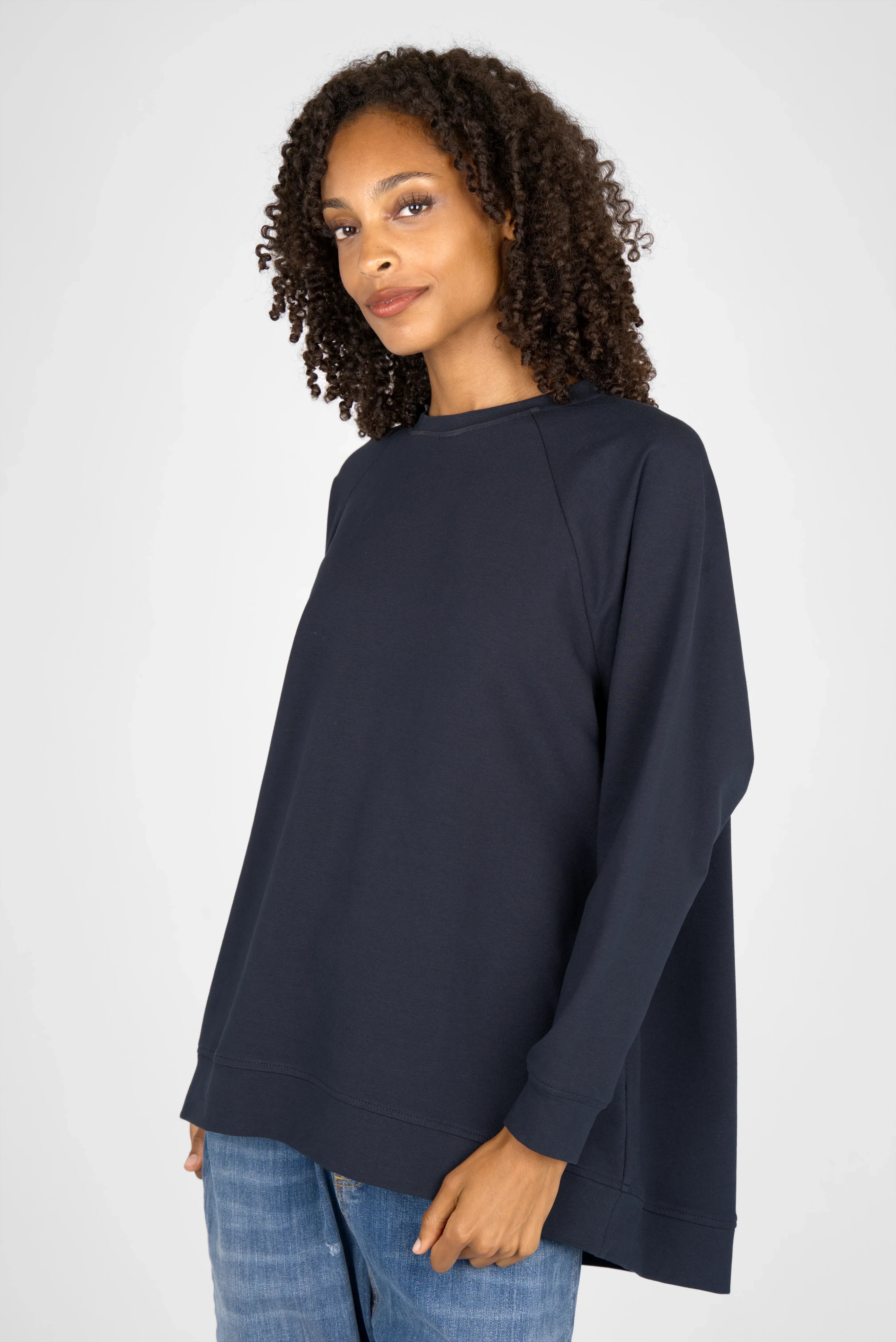 Woman wearing navy oversized GRACEY.K Sweater with raglan sleeves and round neckline