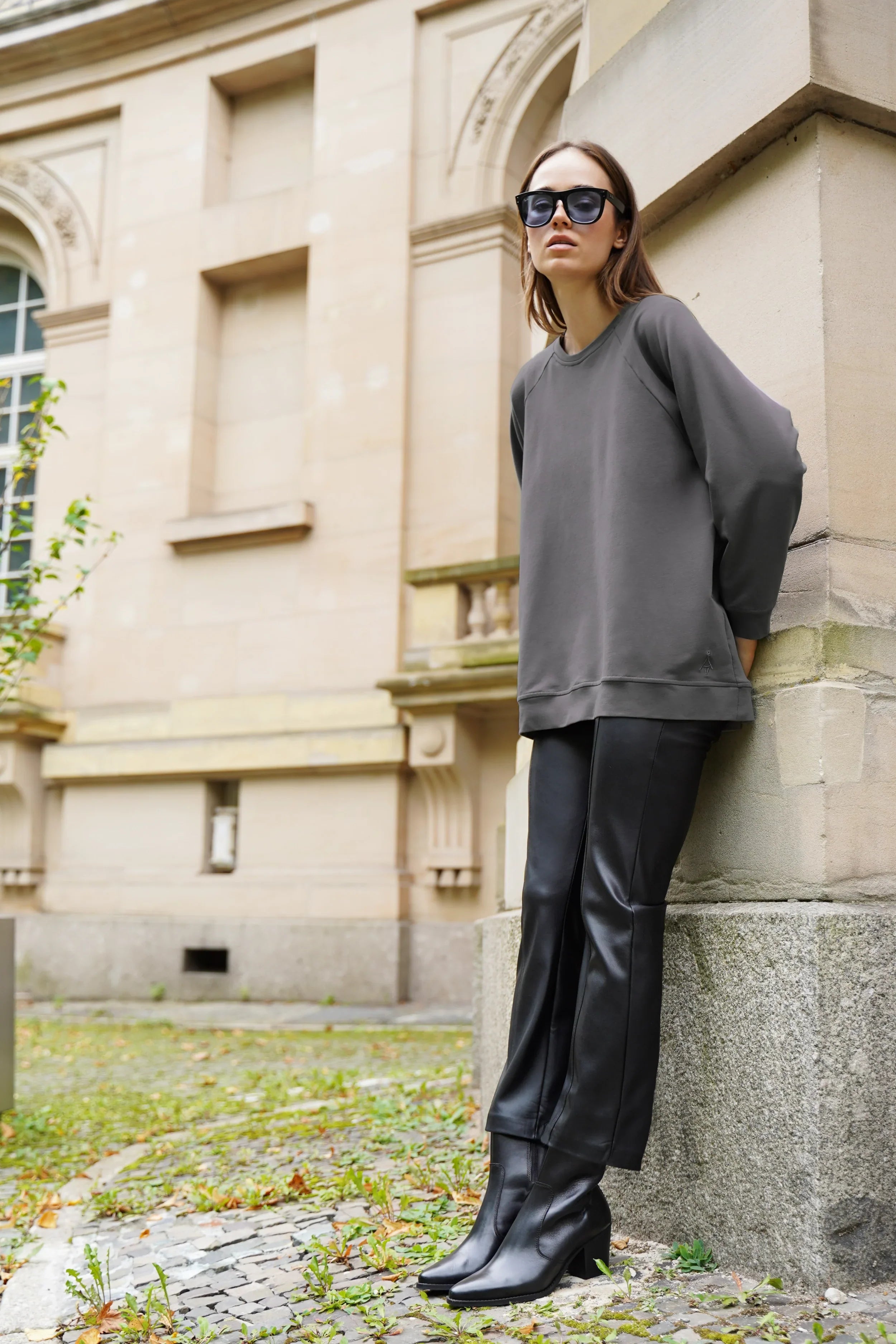 Woman wearing oversized GRACEY.K Sweater with round neckline and tonal logo embroidery outdoors