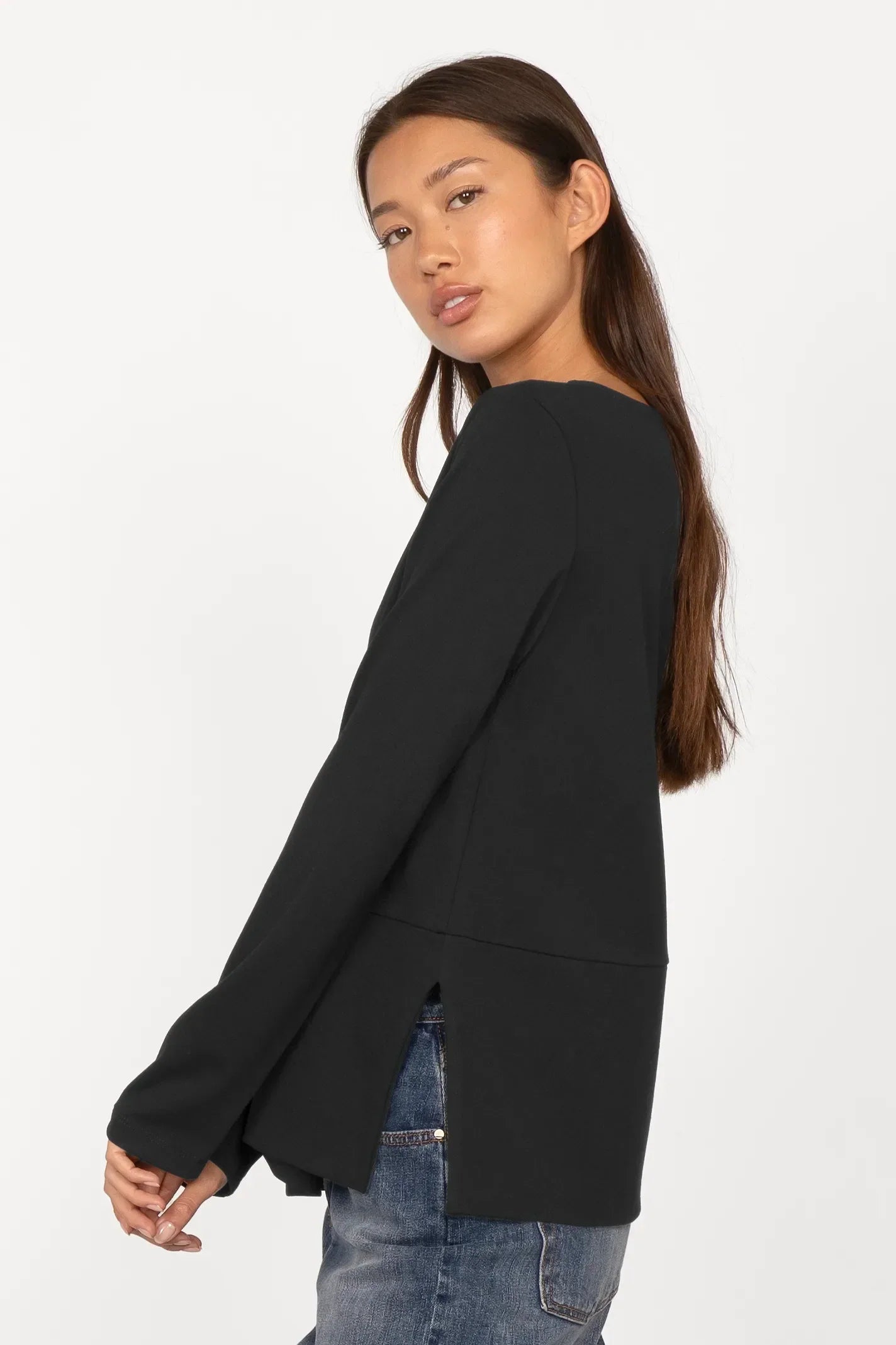 Woman wearing black Haein Clean Jersey longsleeve with U-boat neckline and side slits