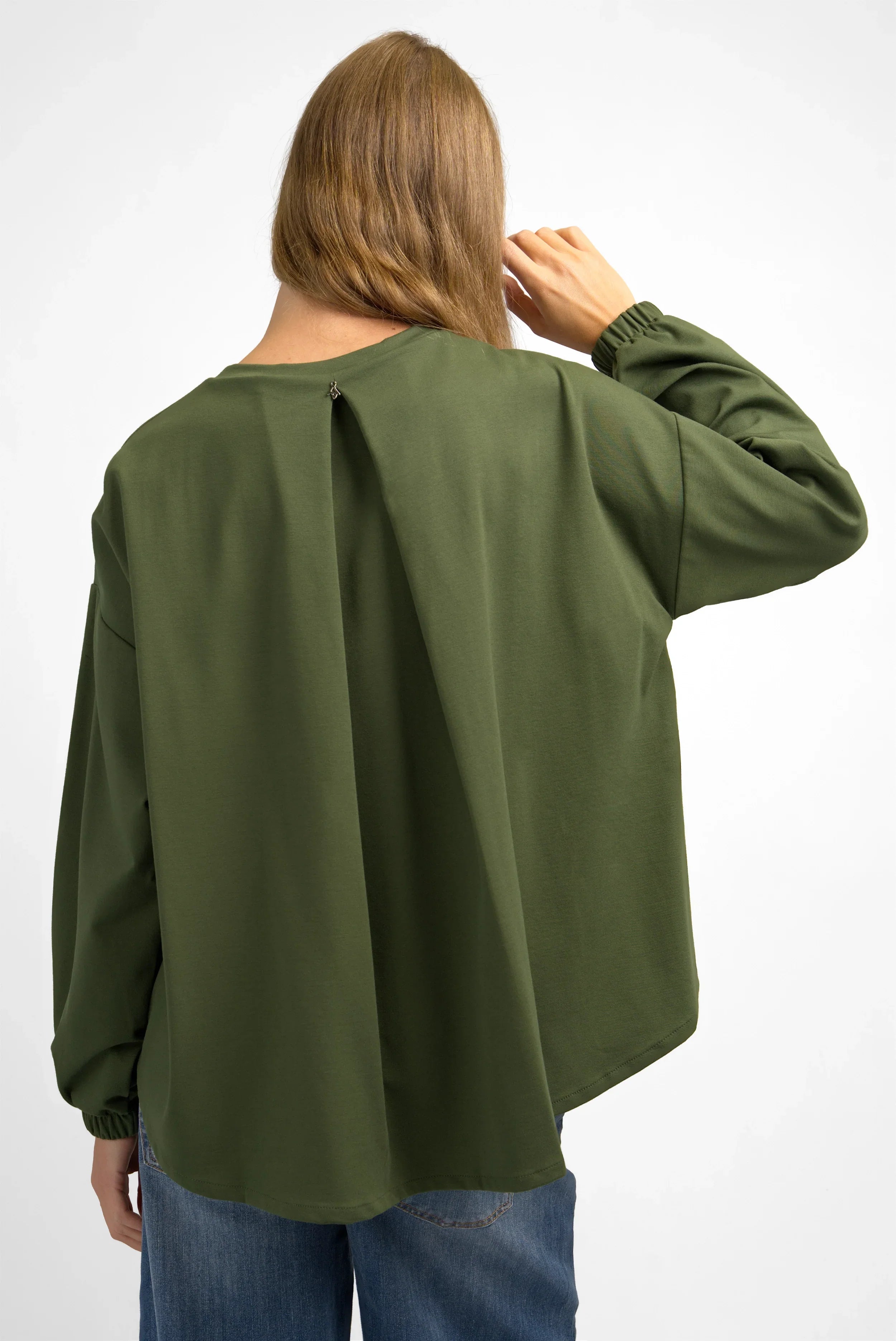 Back view of olive green HAGLA Shirt with relaxed fit and elastic cuffs worn by model