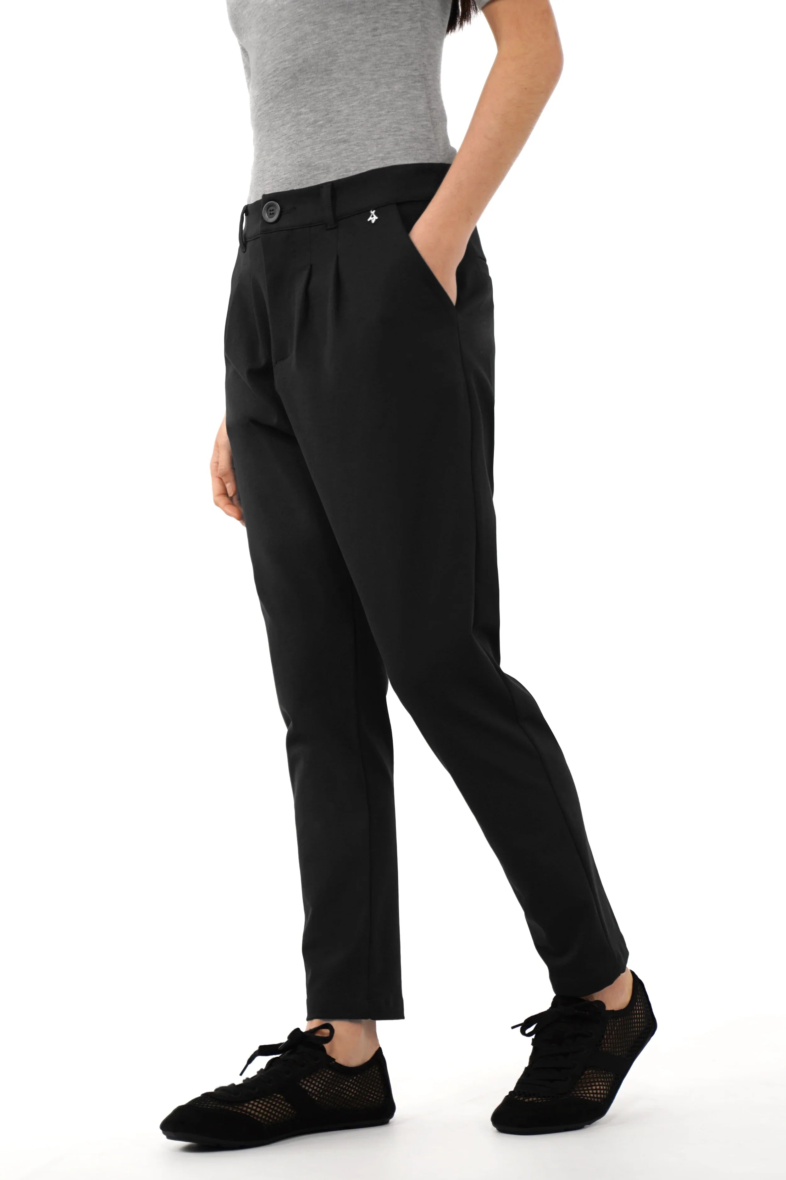 Black tapered pants with relaxed fit and tapered leg, featuring a soft, wrinkle-resistant fabric and zipper closure.