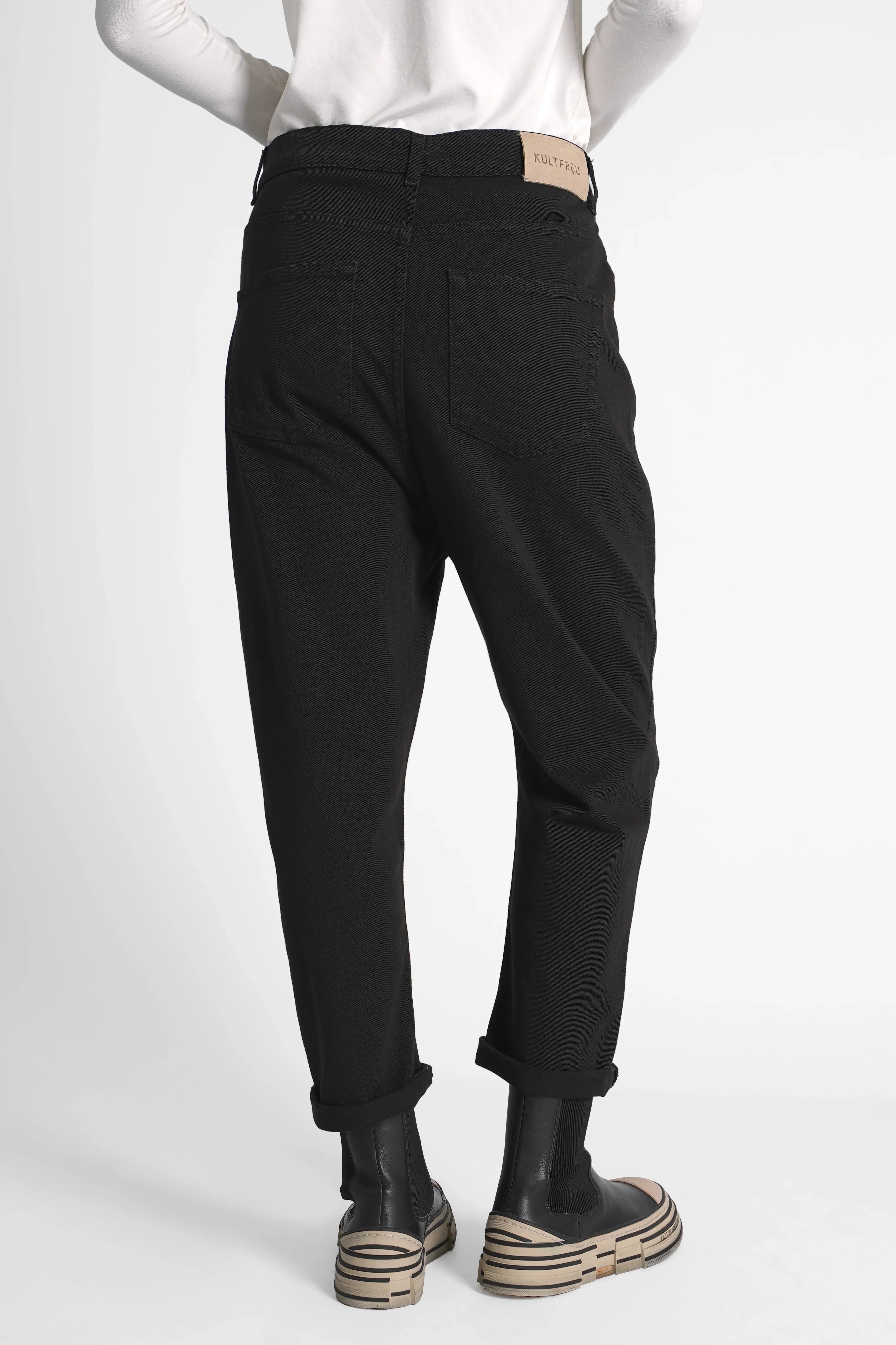 Back view of black JEANY Baggy Jeans with relaxed fit and cuffed hems worn by modelBlack relaxed fit baggy jeans with deep crotch and rolled cuffs modeled from the back