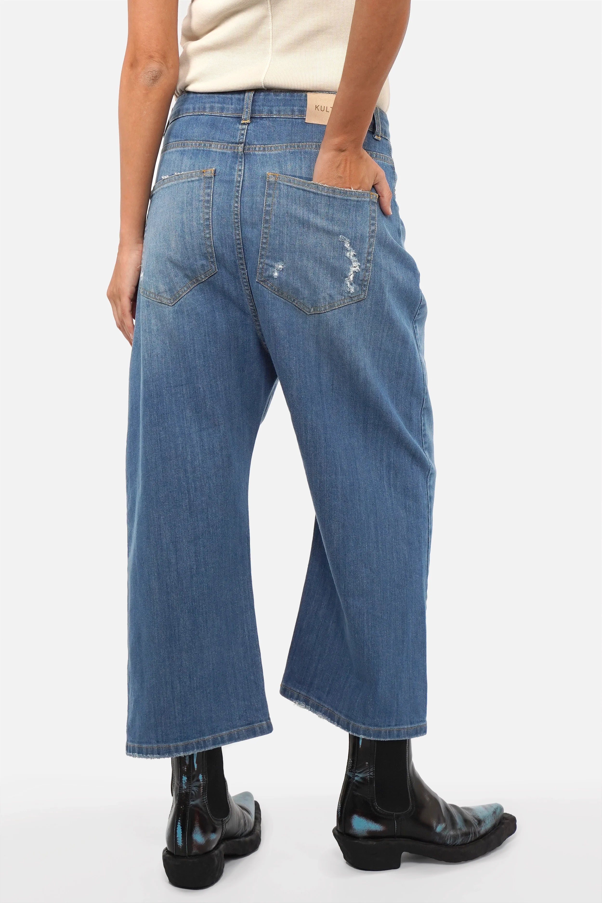 Model wearing Italian-made JENYA baggy jeans with destroyed wash and relaxed fit