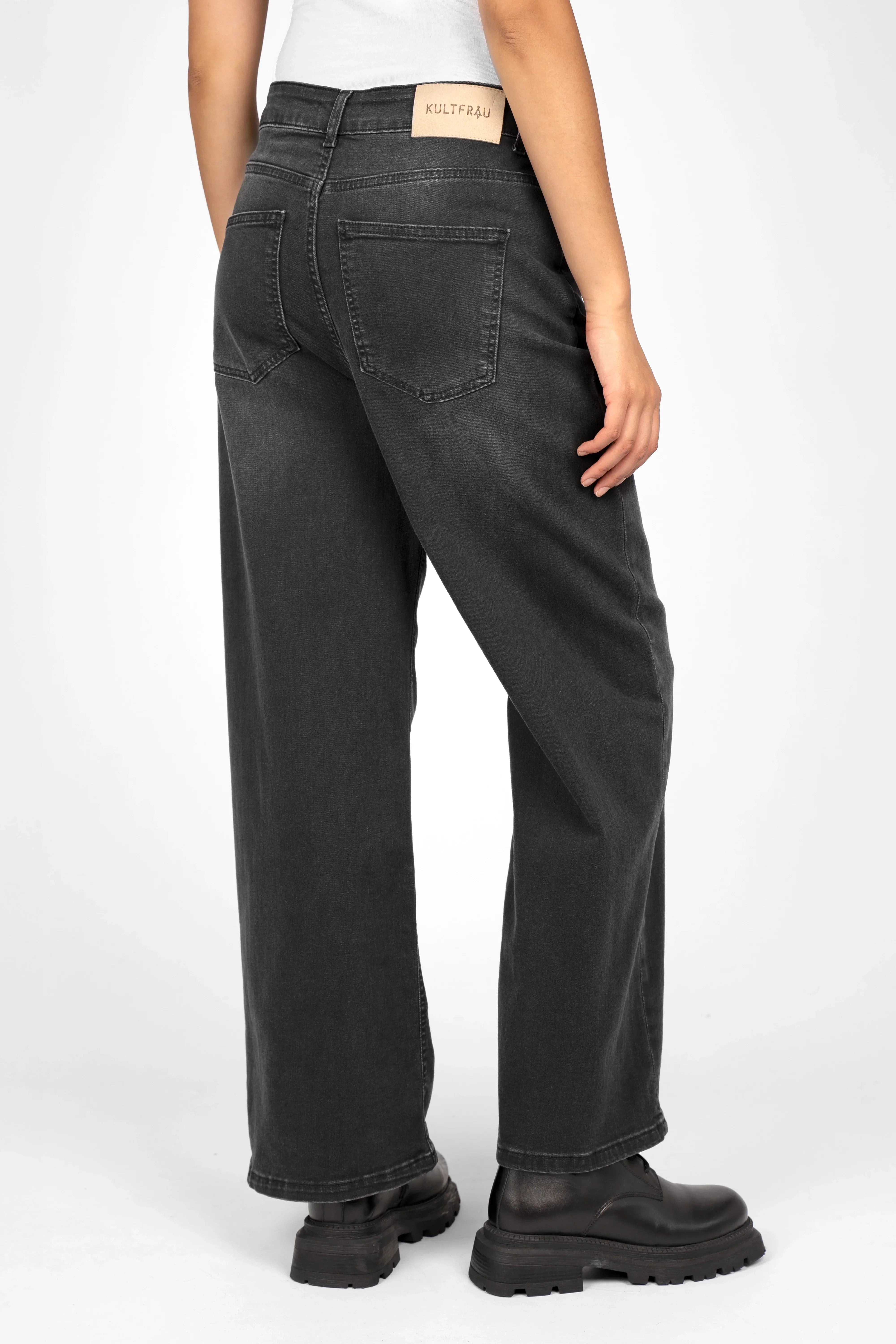 Back view of model wearing JOOSY Wide Leg Jeans in faded black with relaxed fit and wide straight legs