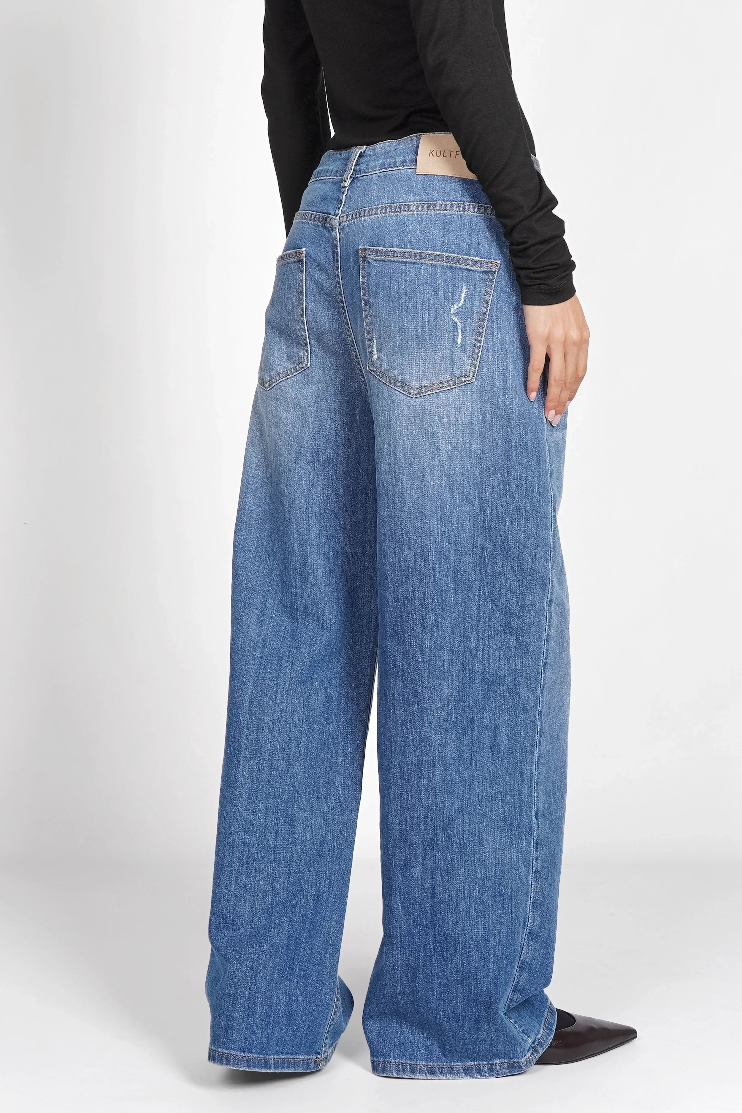 JOOSY Wide Leg Jeans in medium blue with relaxed fit and wide straight legs, featuring subtle faded and worn details, made from soft, slightly stretchy denim.