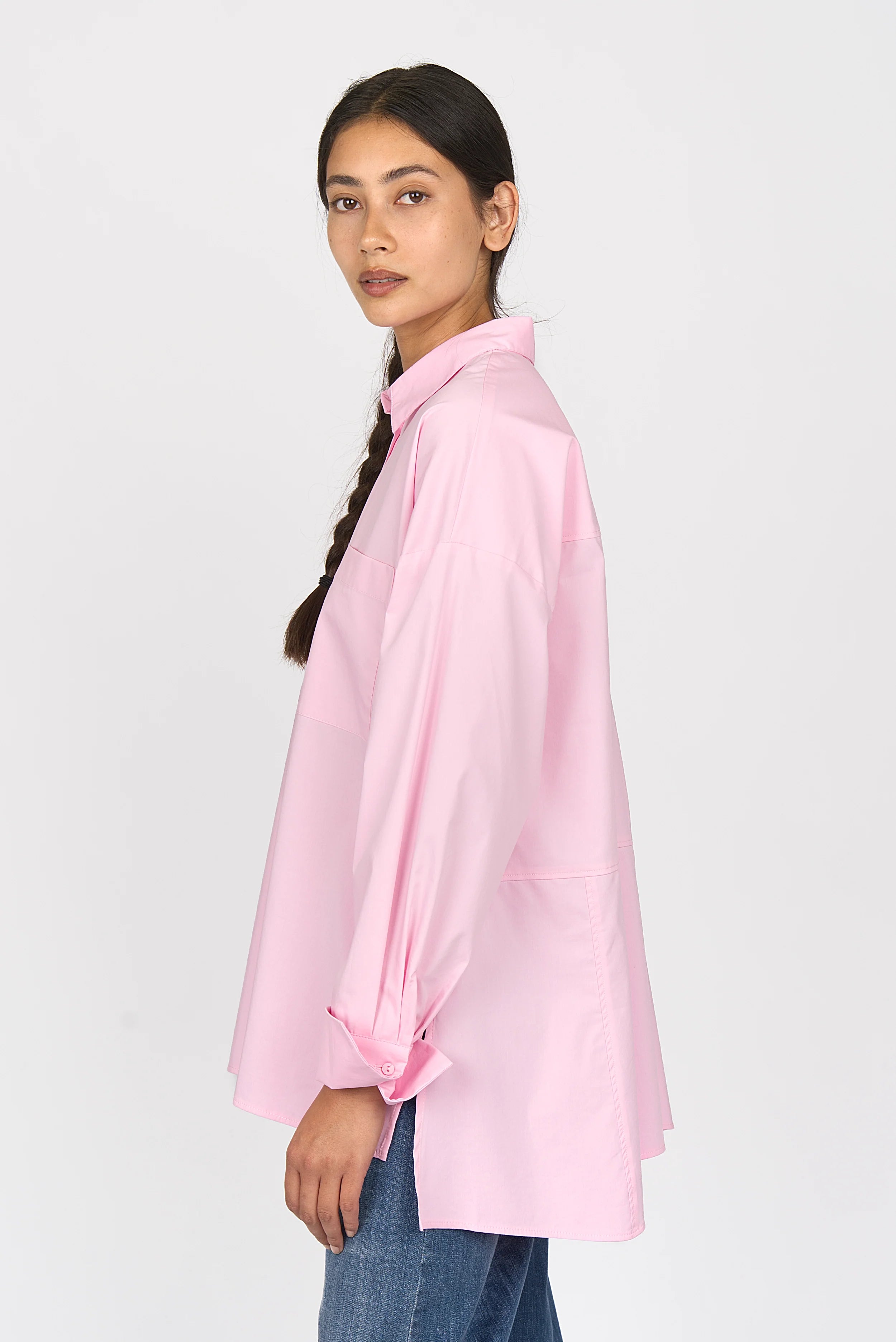 LEA.K Loose Fit pink cotton poplin blouse with loose fit, long back, deep side slits, chest pockets, and button cuffs worn by model