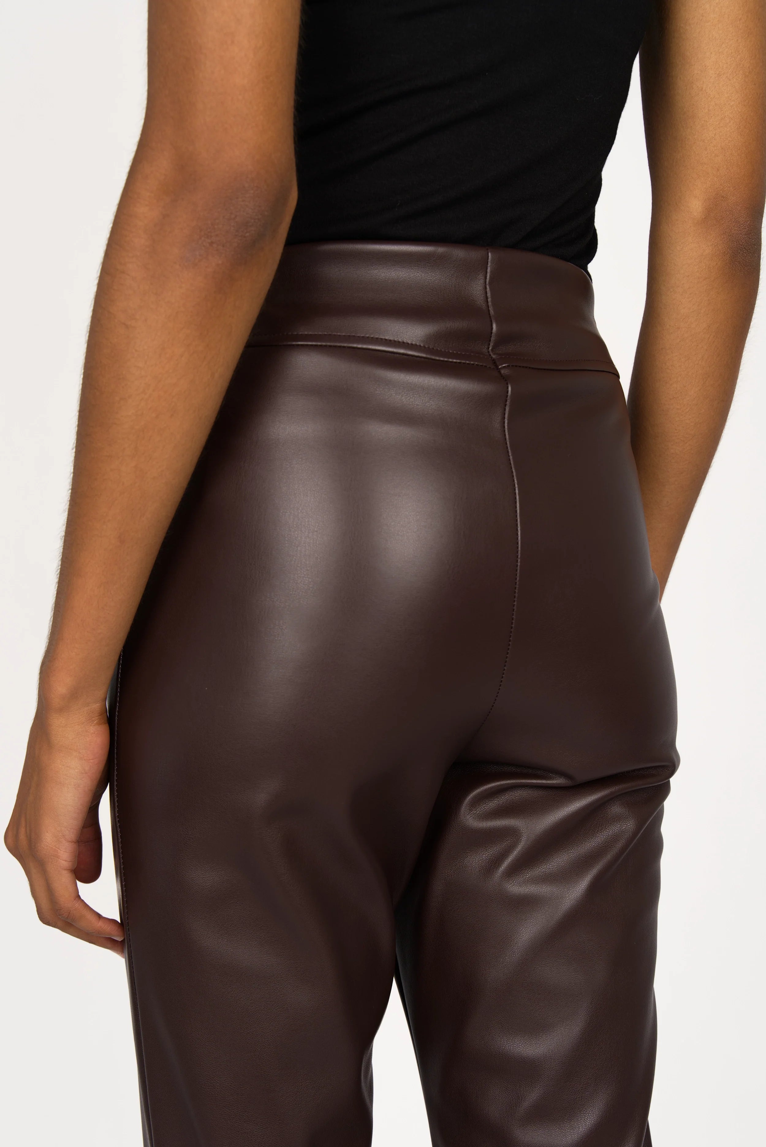 Back view of LIMGARD Flared Eco-Lederhose high-waist cropped brown eco-leather pants with flared leg and elastic waistband