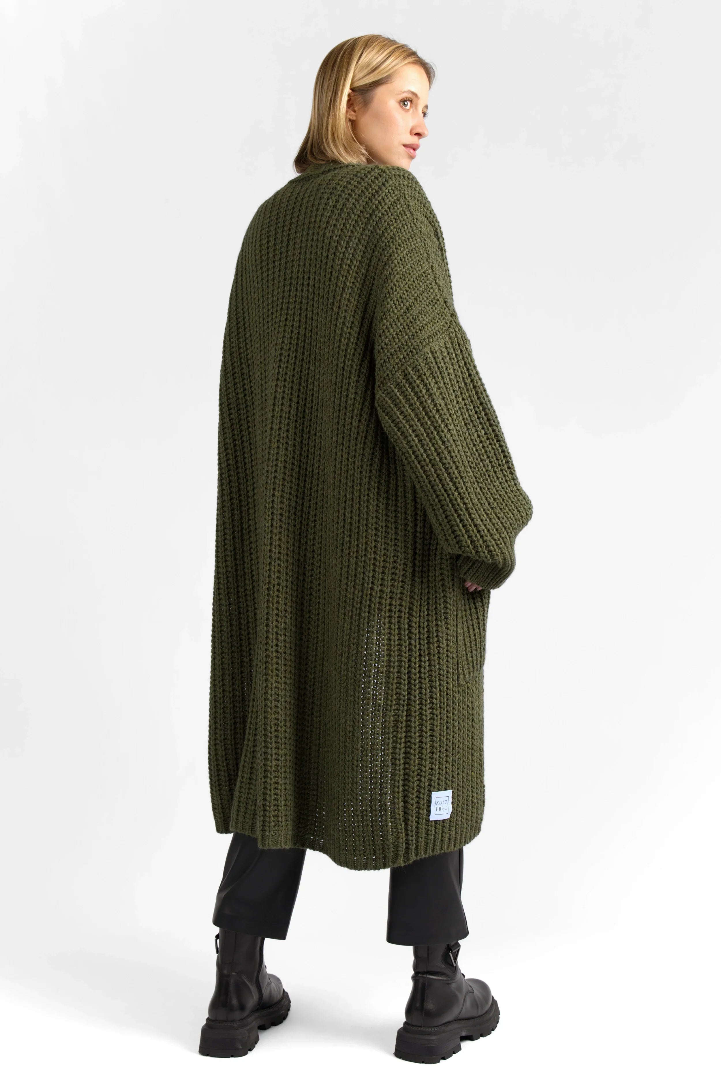 Woman wearing oversized green LOLLYTA Strickcardigan knit cardigan with dropped shoulders and patch pockets, styled open and cozy.