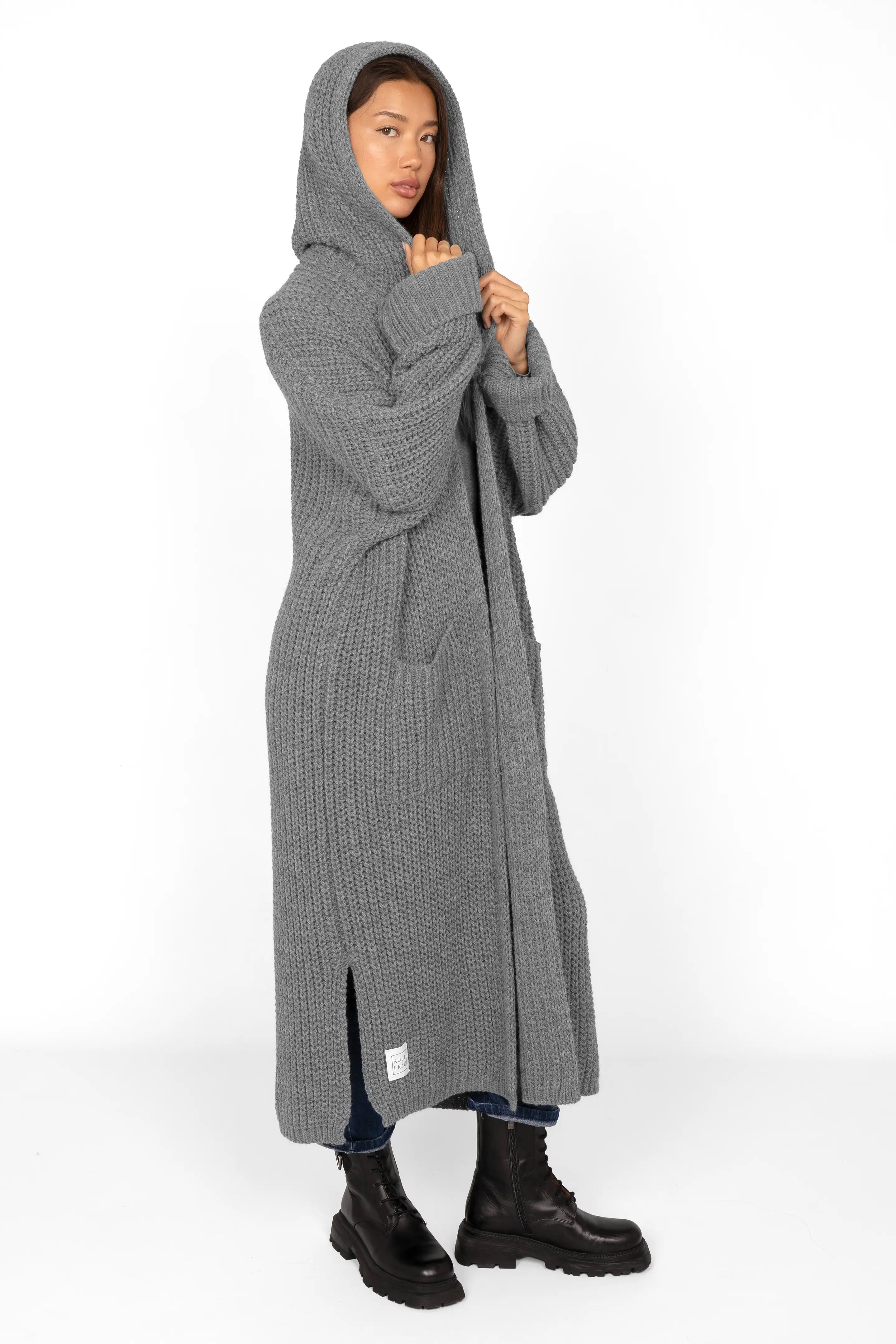 Oversized grey long cardigan with hood and pockets worn by woman