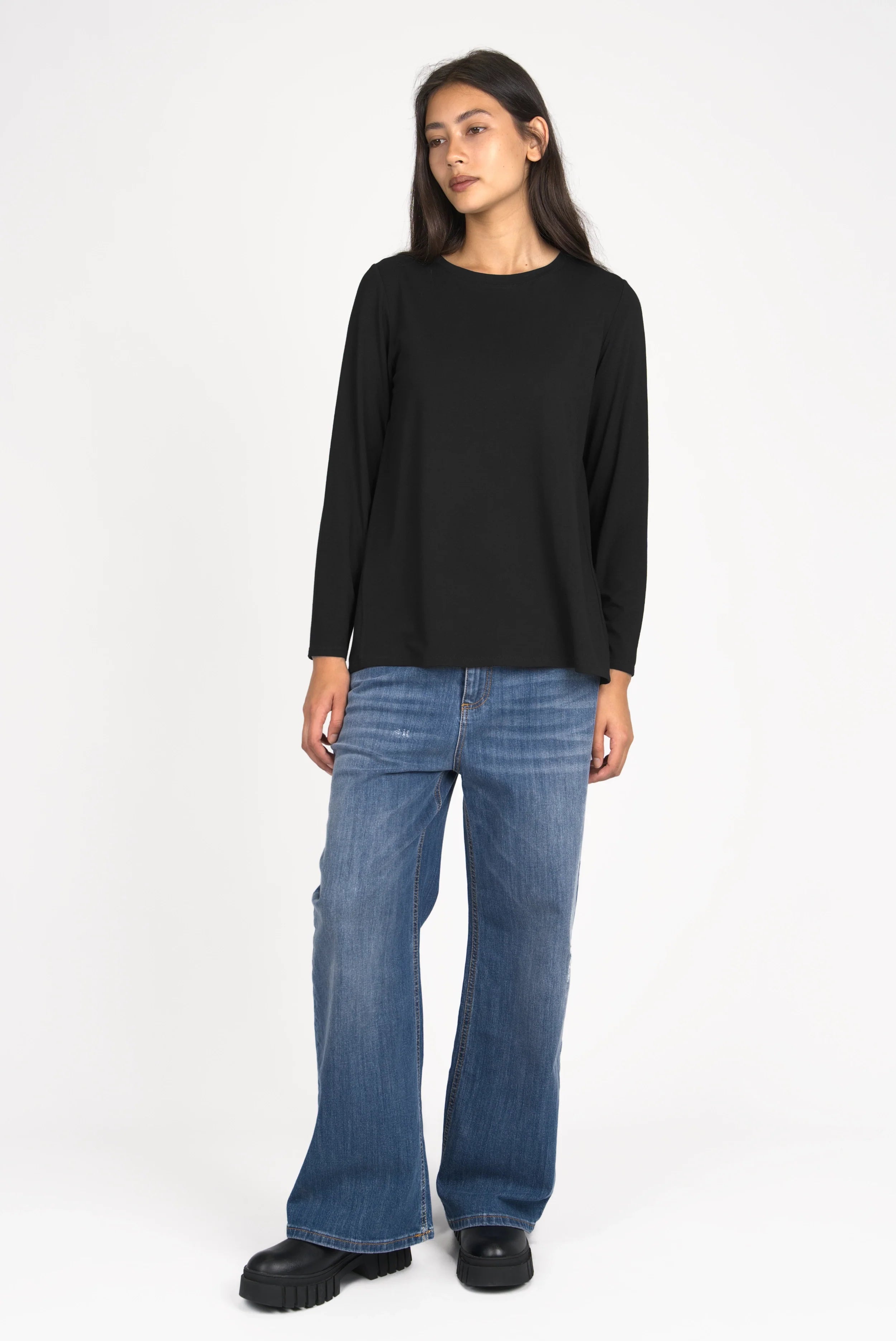 Woman wearing black LYLLDA Viskose Longsleeve with round neckline and relaxed fit paired with blue jeans
