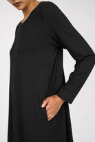 Black LYLLDA A-line dress with round neckline, long sleeves, and side pockets in soft flowing viscose fabric