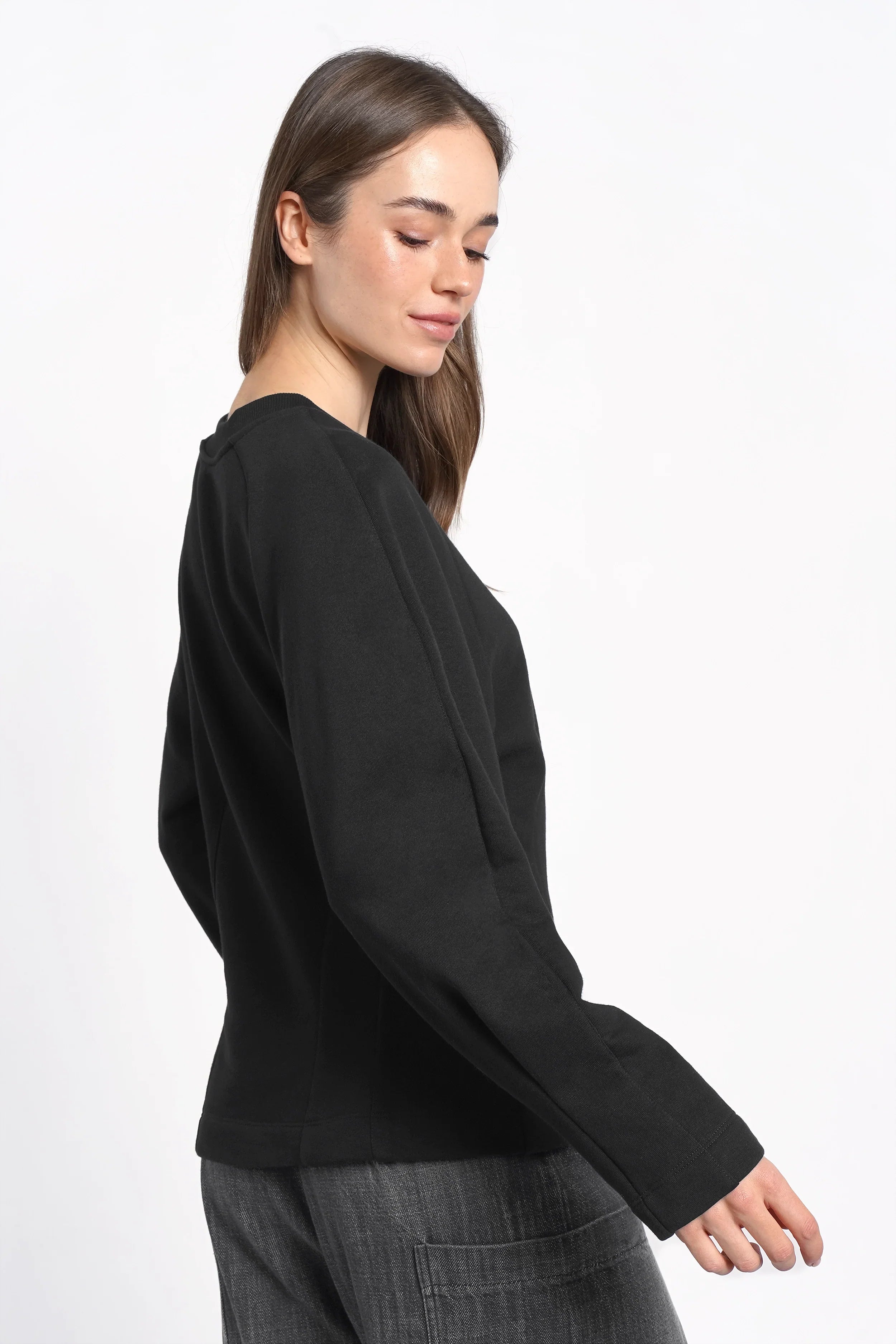 Black MALVEA Sweater with relaxed fit and subtle seam details worn by a woman