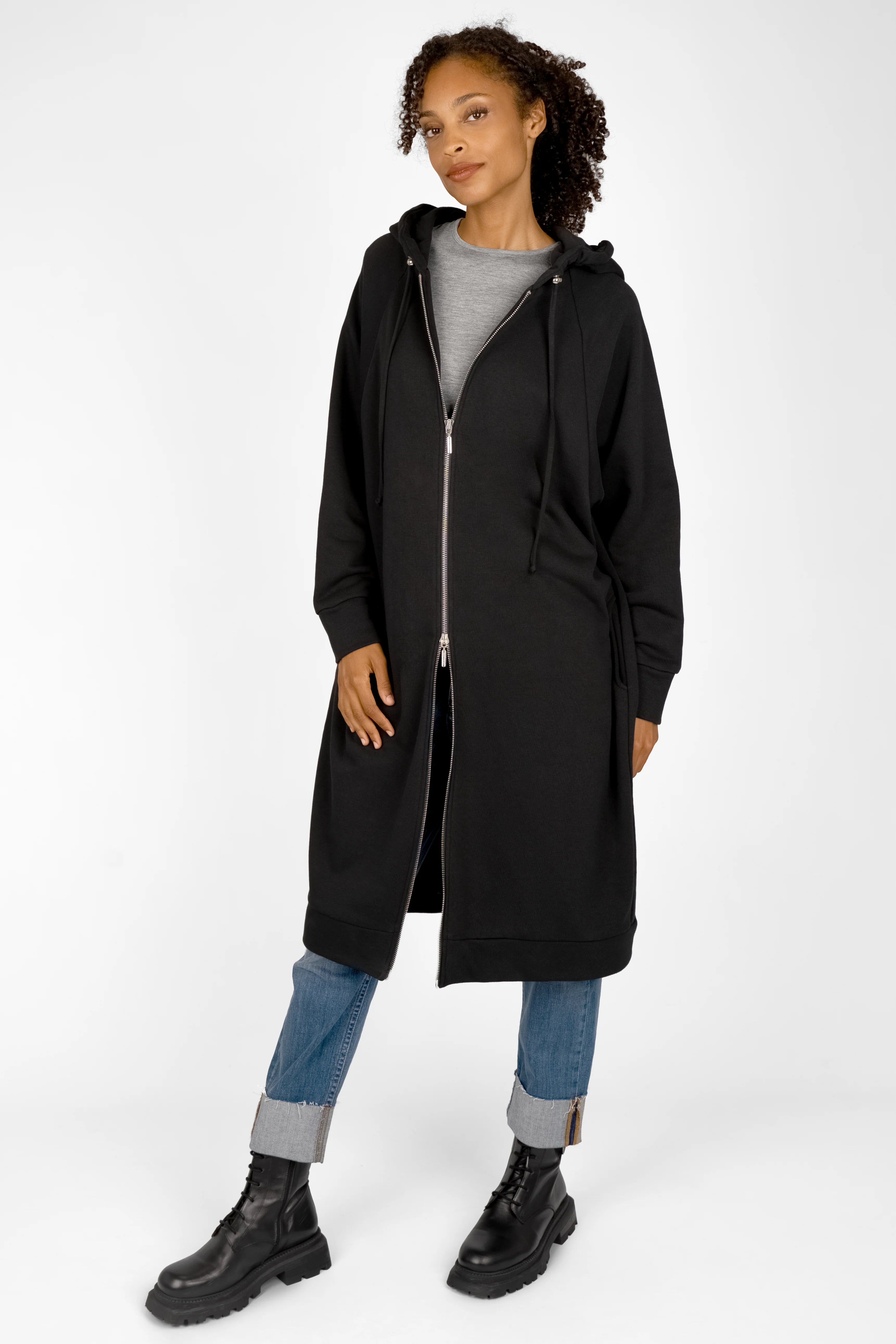 Black MANDI.K Longzip-Hoodie with two-way zipper, large hood, side pockets, and relaxed fit worn with jeans and boots