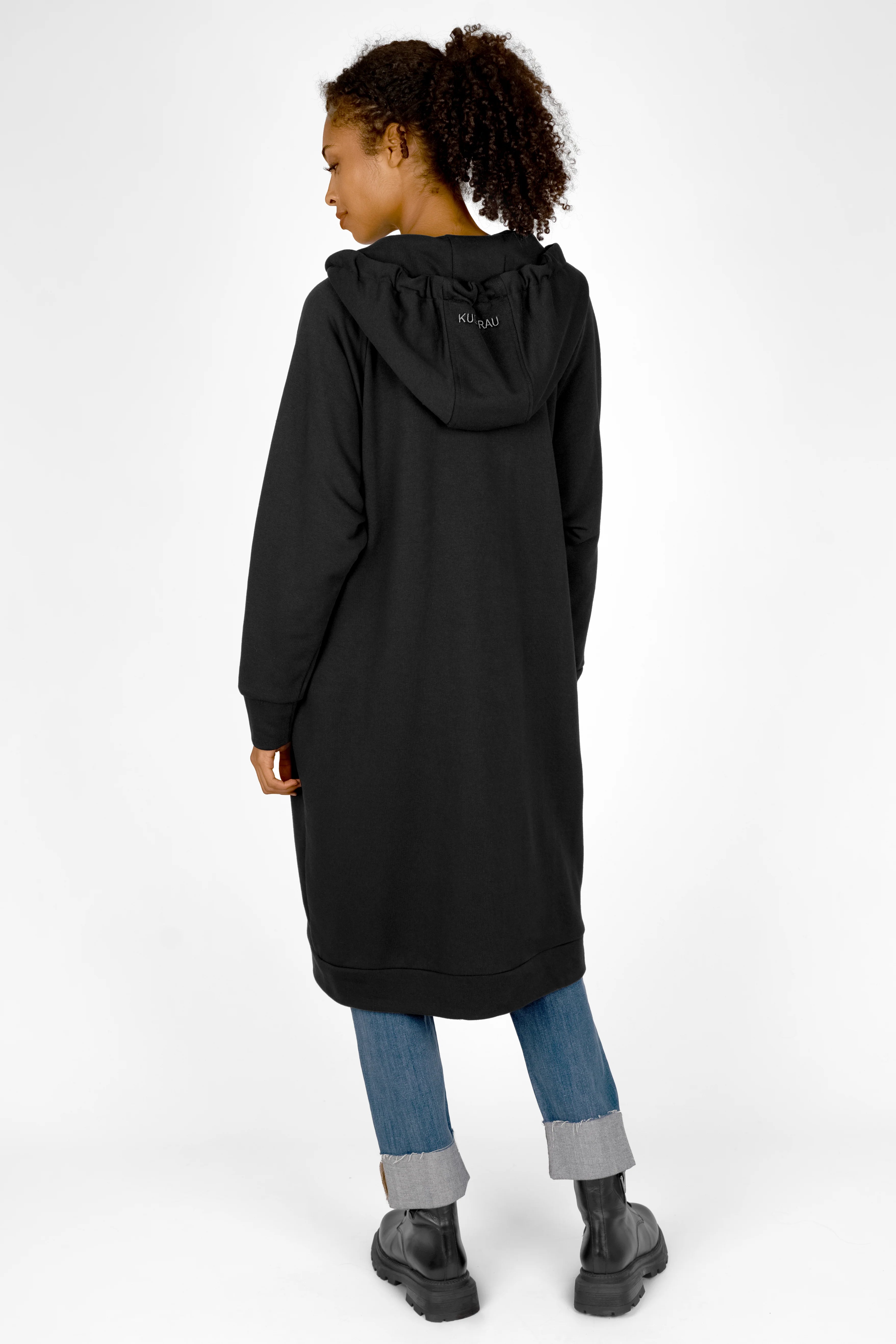 Woman wearing black MANDI.K Longzip-Hoodie with large hood and side pockets viewed from the back