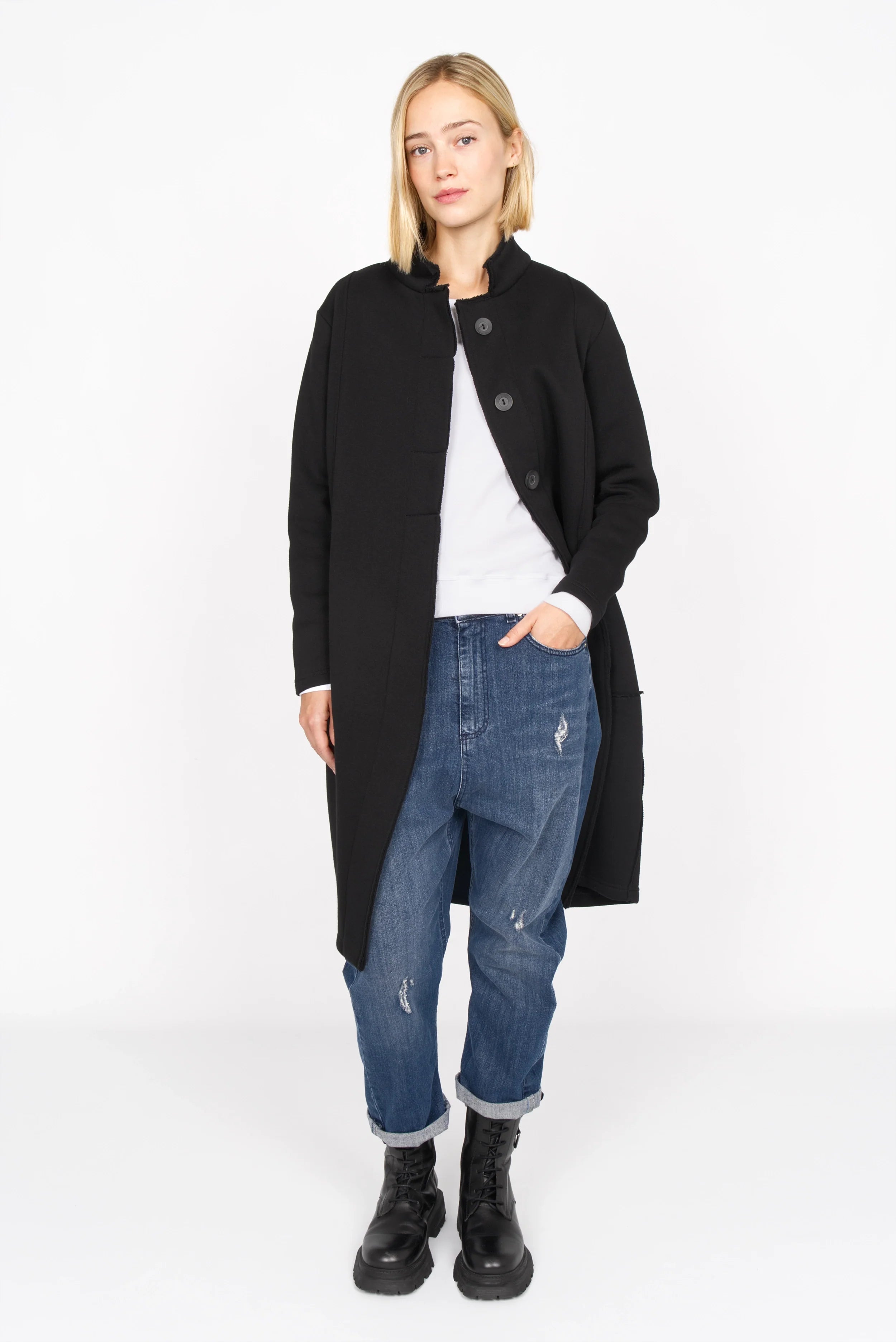 Black MANEY Sweatmantel with concealed buttons, soft jersey fabric, and balloon silhouette worn with casual jeans and boots