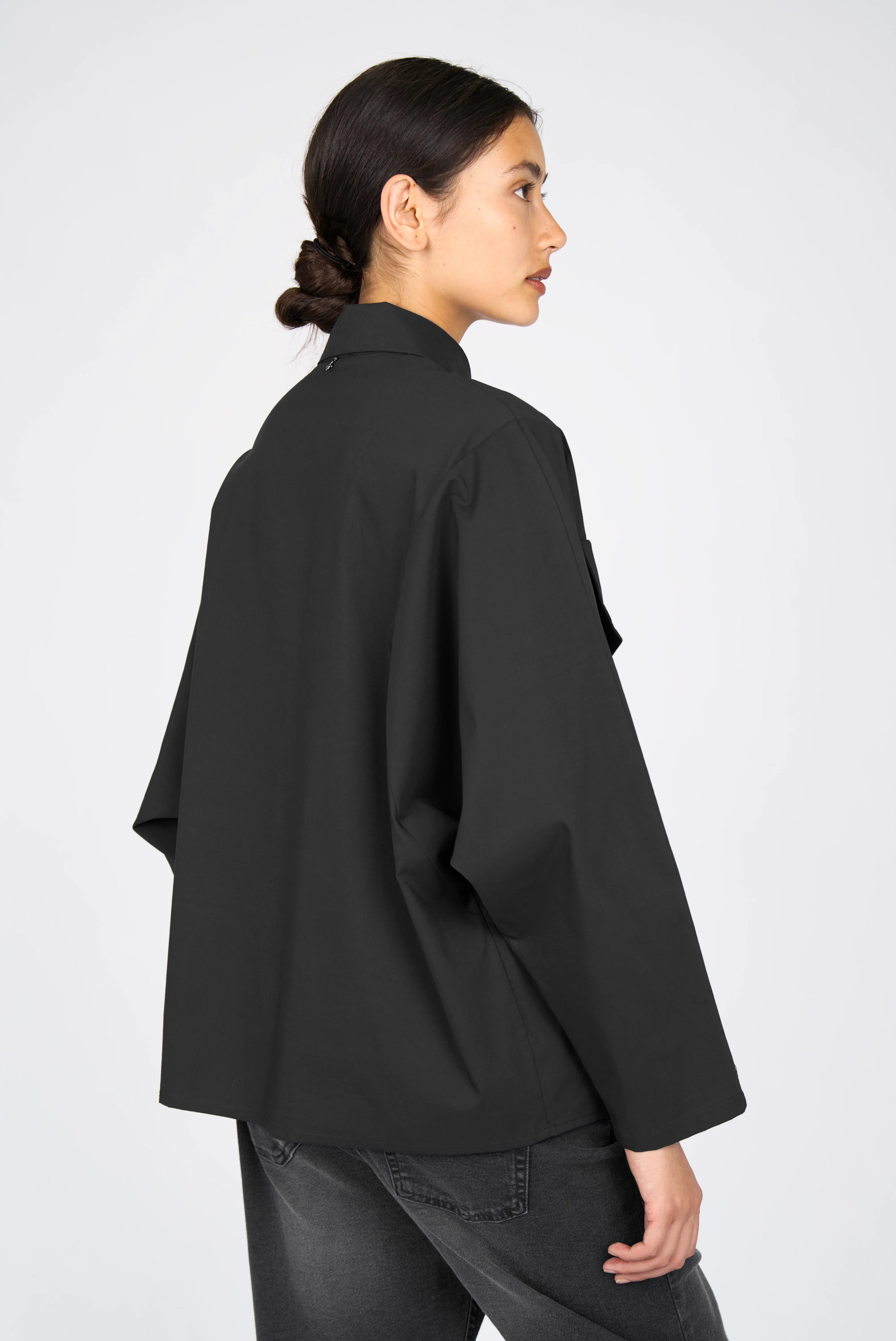 Relaxed fit MELIZA Bluse in black popeline with bat-cut sleeves and asymmetrical pockets viewed from back