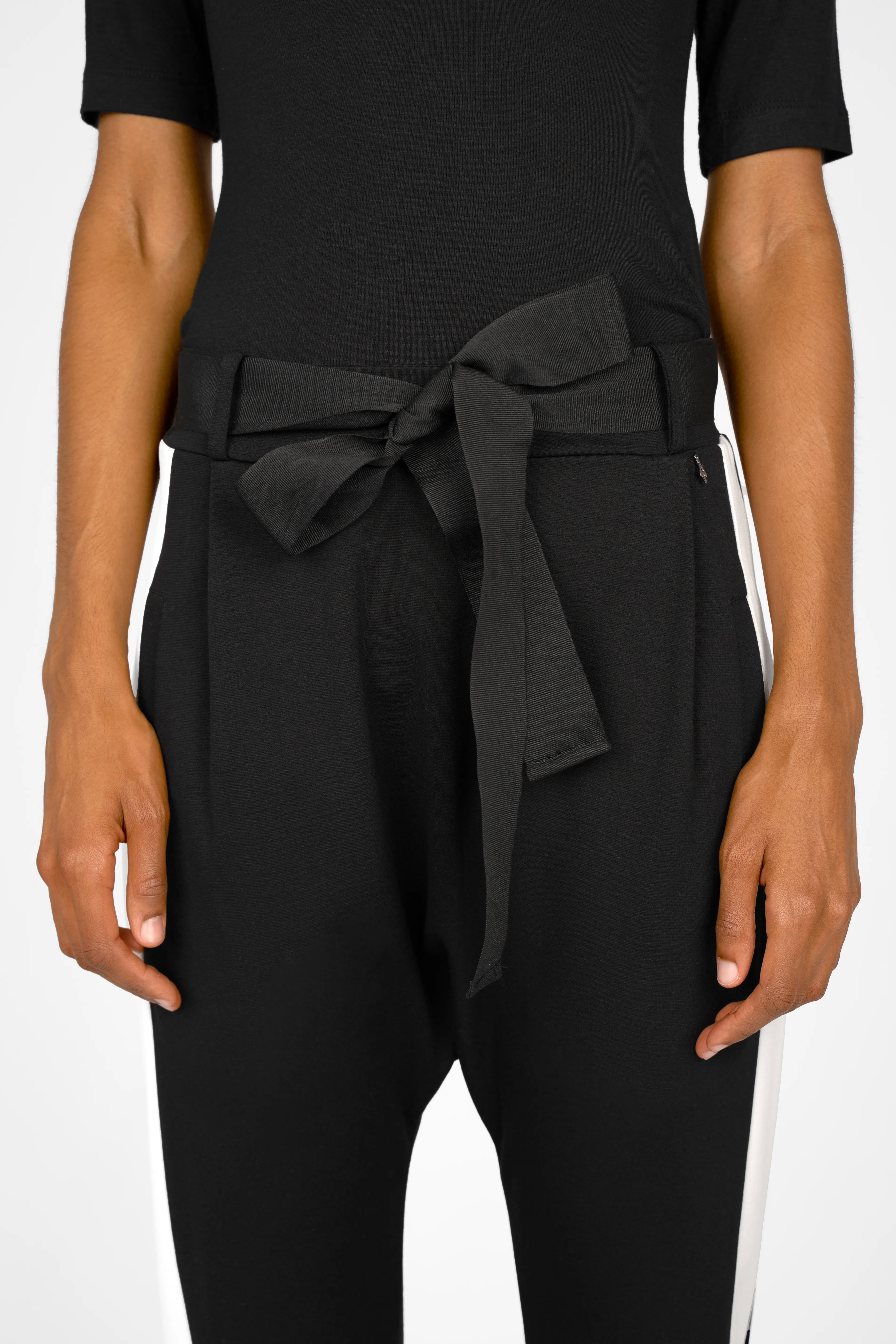 Black MYRAN tapered sweathose with white side stripes, adjustable waist tie, and side pockets.