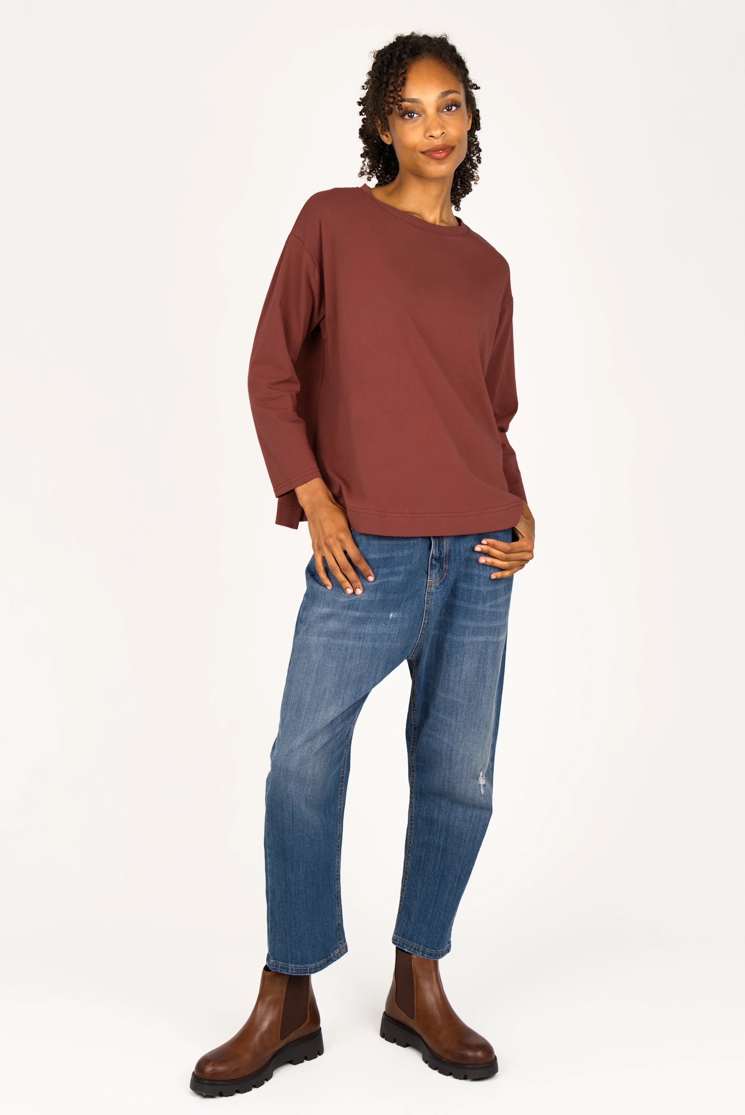 Woman wearing NITI.K Langarm Shirt in brown with relaxed fit and round neckline paired with blue jeans and brown boots