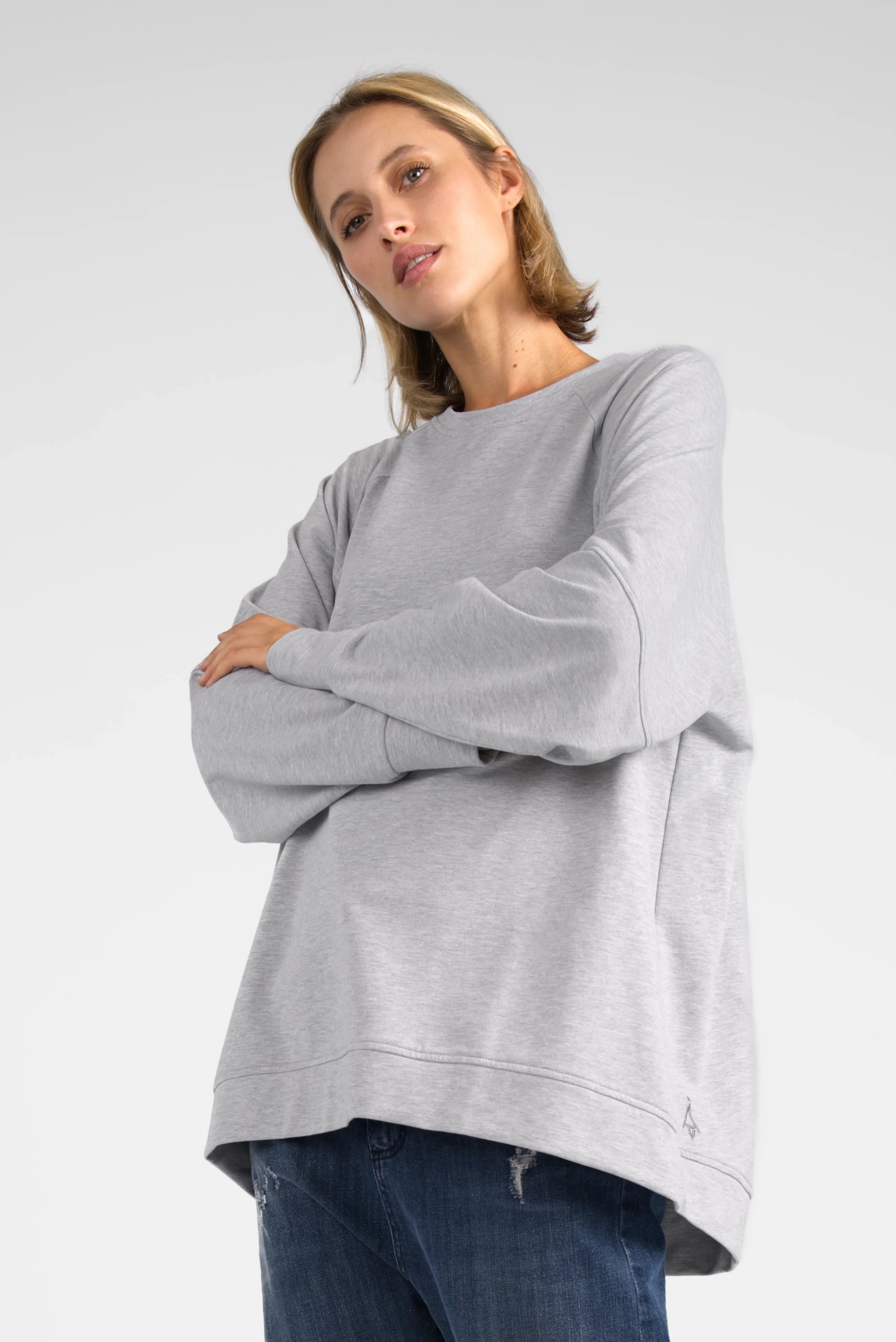 Woman wearing light grey SELKA Sweater with raglan sleeves and relaxed A-line fit