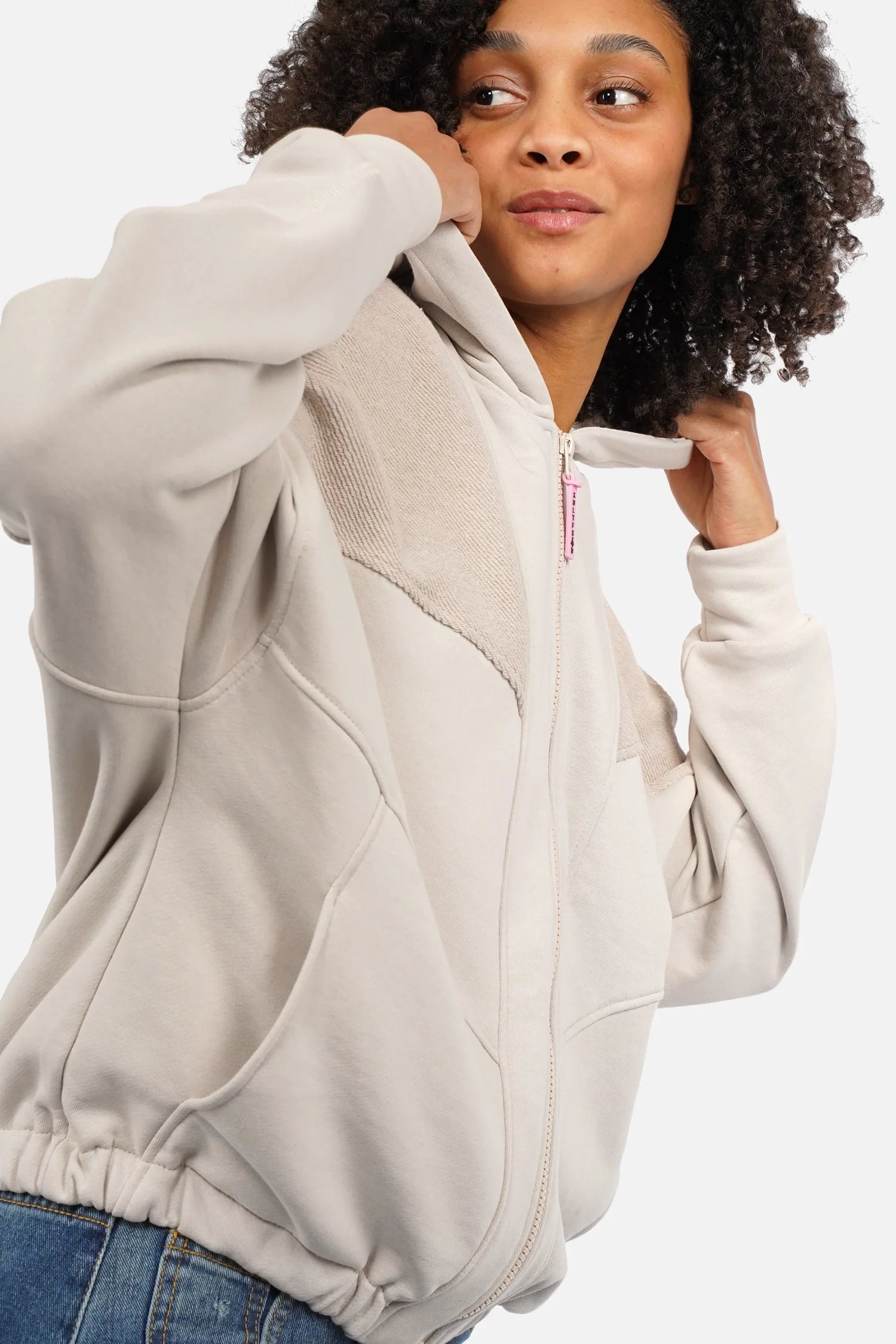 Woman wearing SOVIA oversized zip-hoodie with panel seams and pink logo zipper