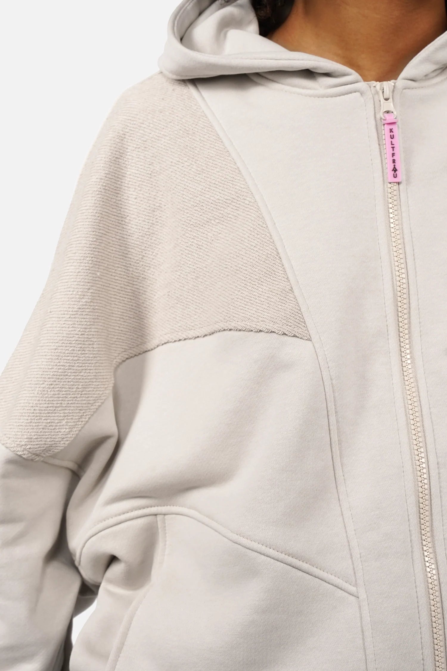 Oversized zip-hoodie with panel design, side pockets, and pink logo zipper