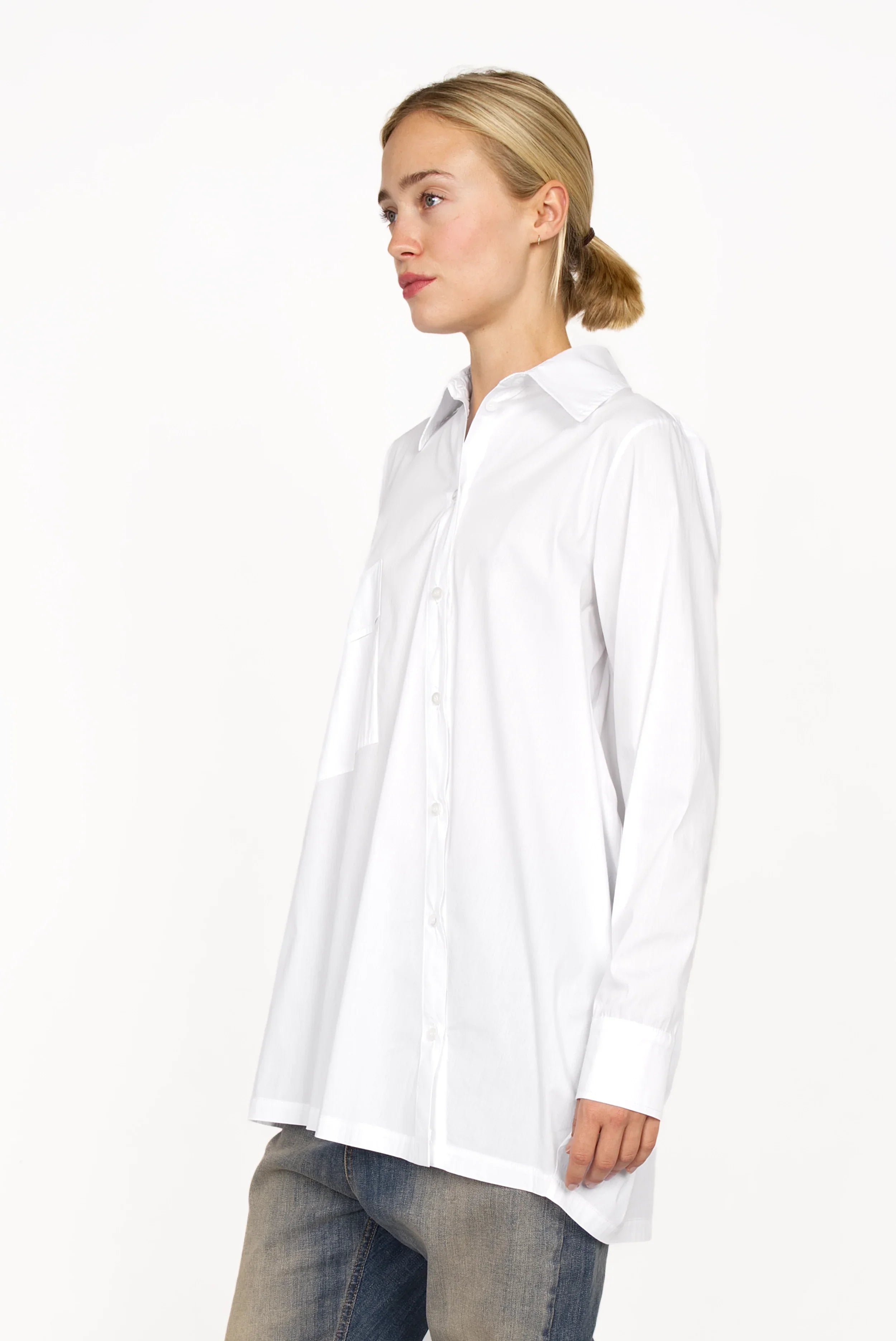 White oversized Hemdbluse with asymmetrical button placket and dropped shoulders on model