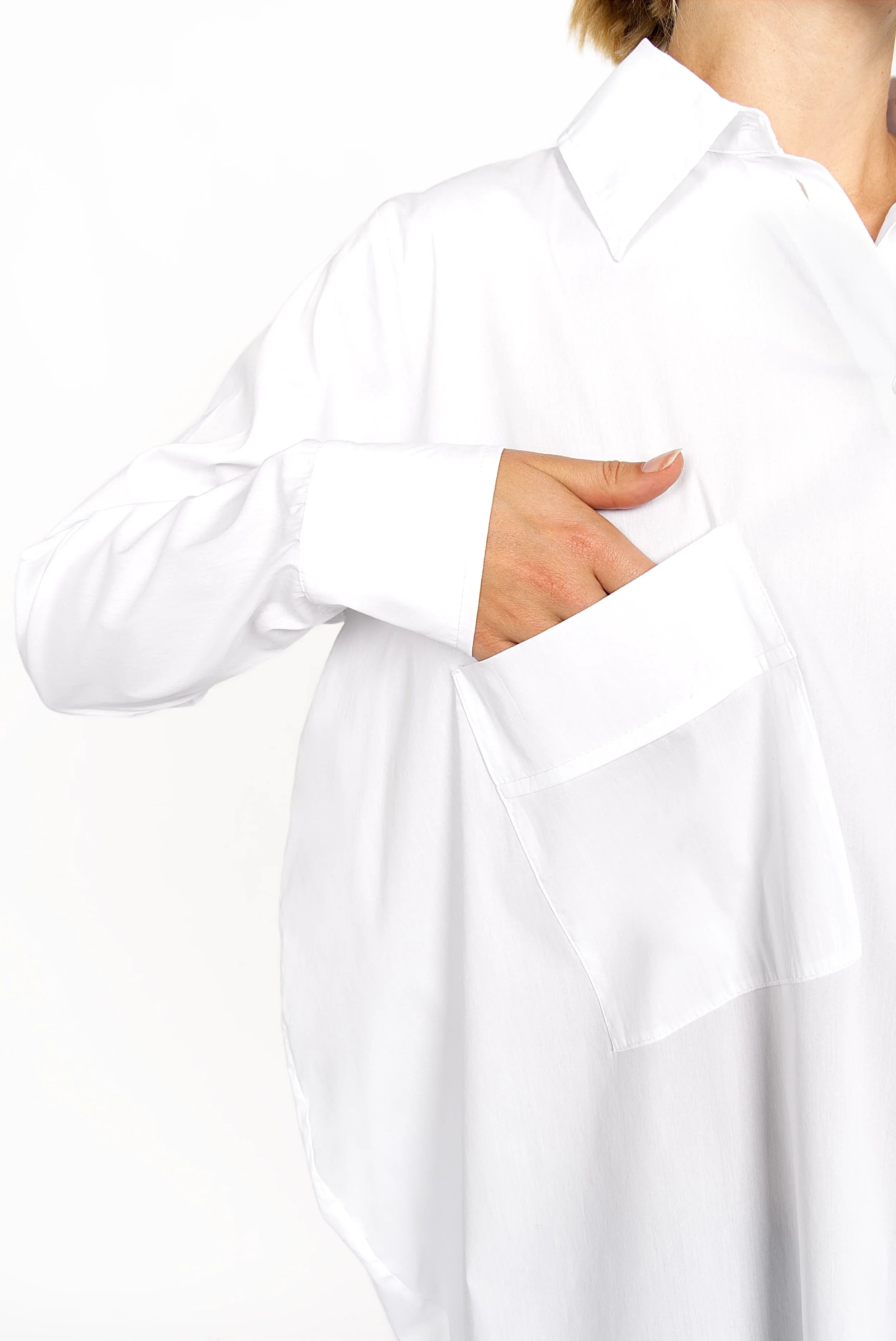 White oversized Hemdbluse with asymmetrical button placket and dropped shoulders, long sleeves, and chest pocket.