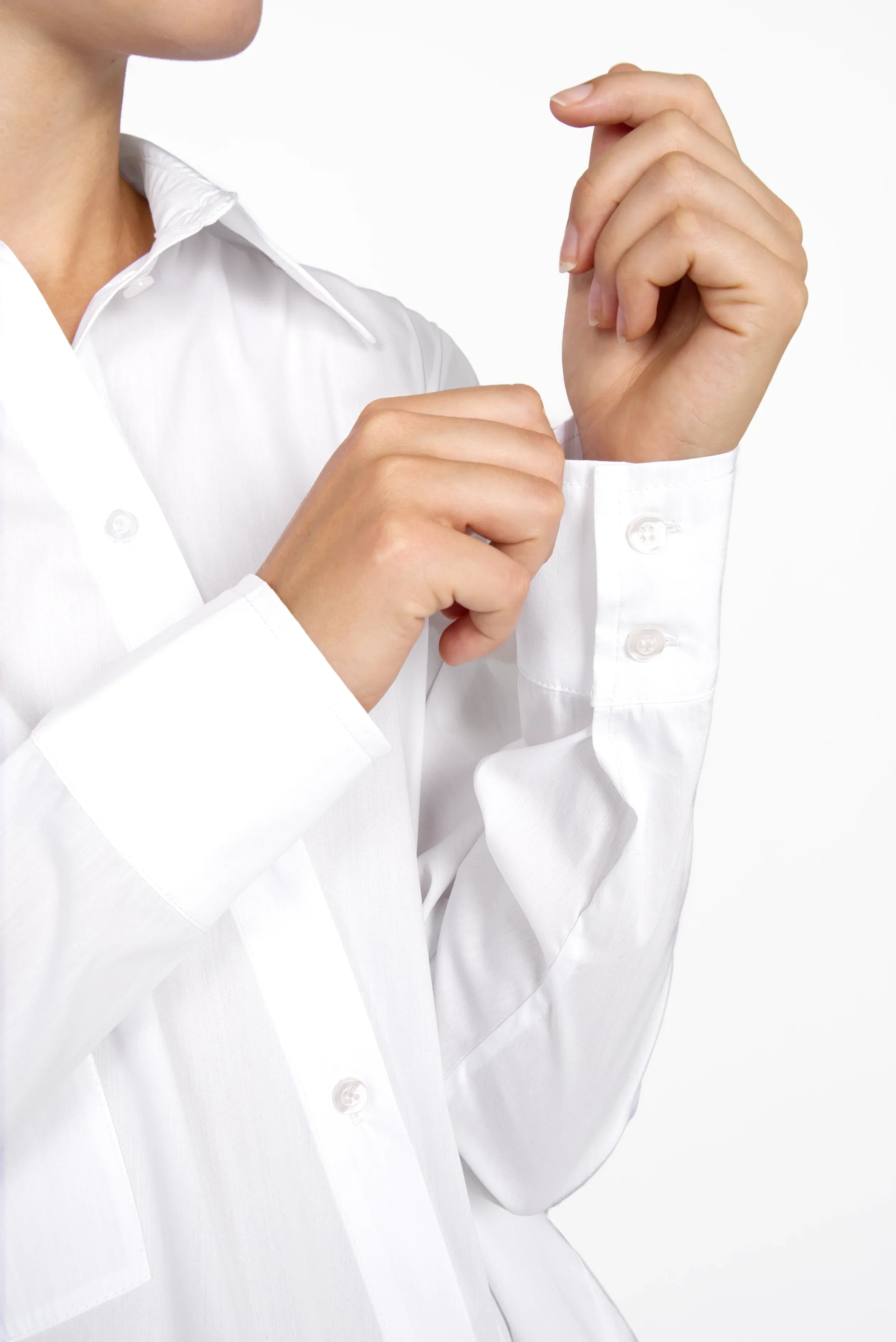 White oversized Hemdbluse with asymmetrical button placket and long sleeves, made from cotton-polyamide blend with elastane.