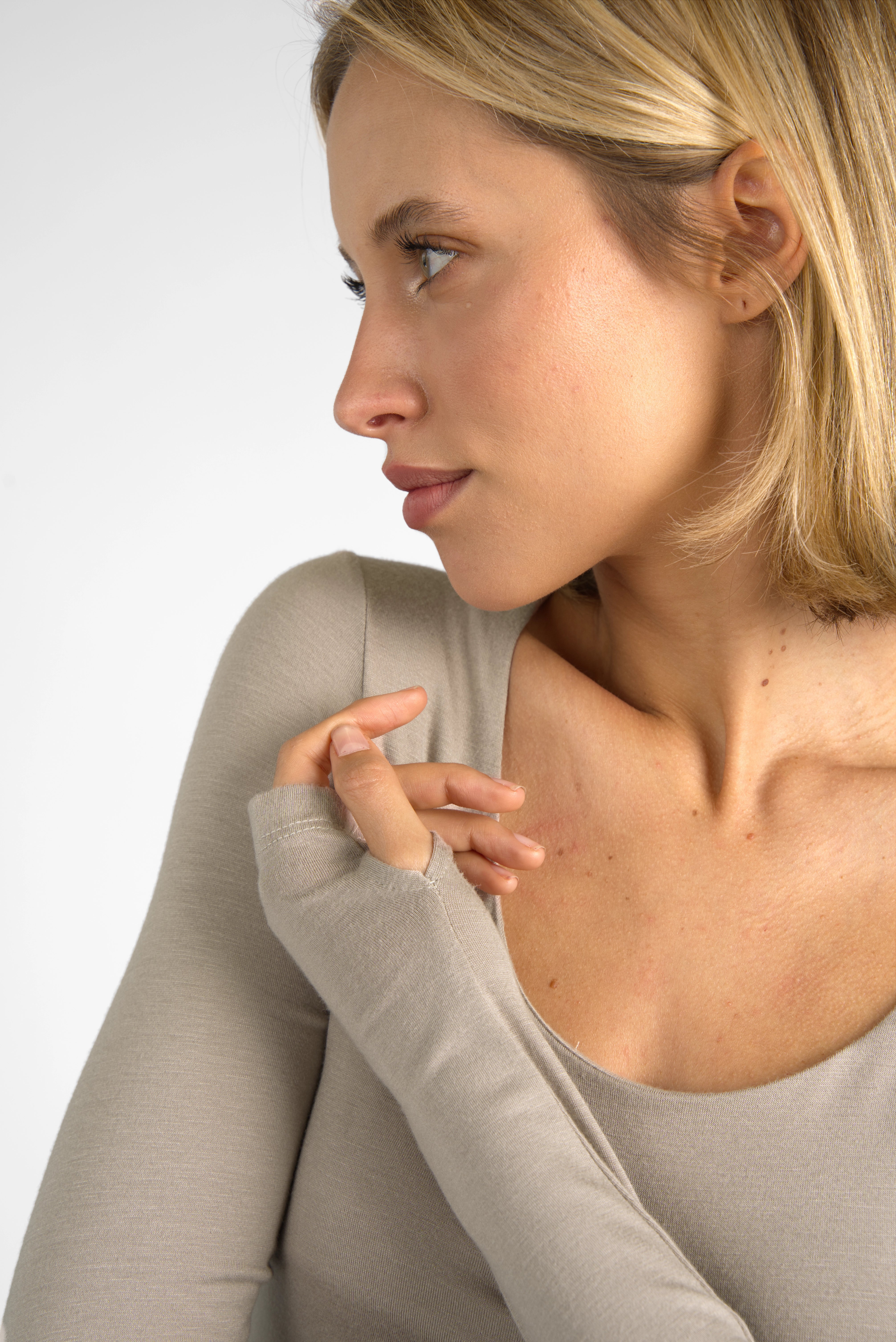 Woman wearing beige VALUM Longsleeve with U-boat neckline and thumb holes on long sleeves