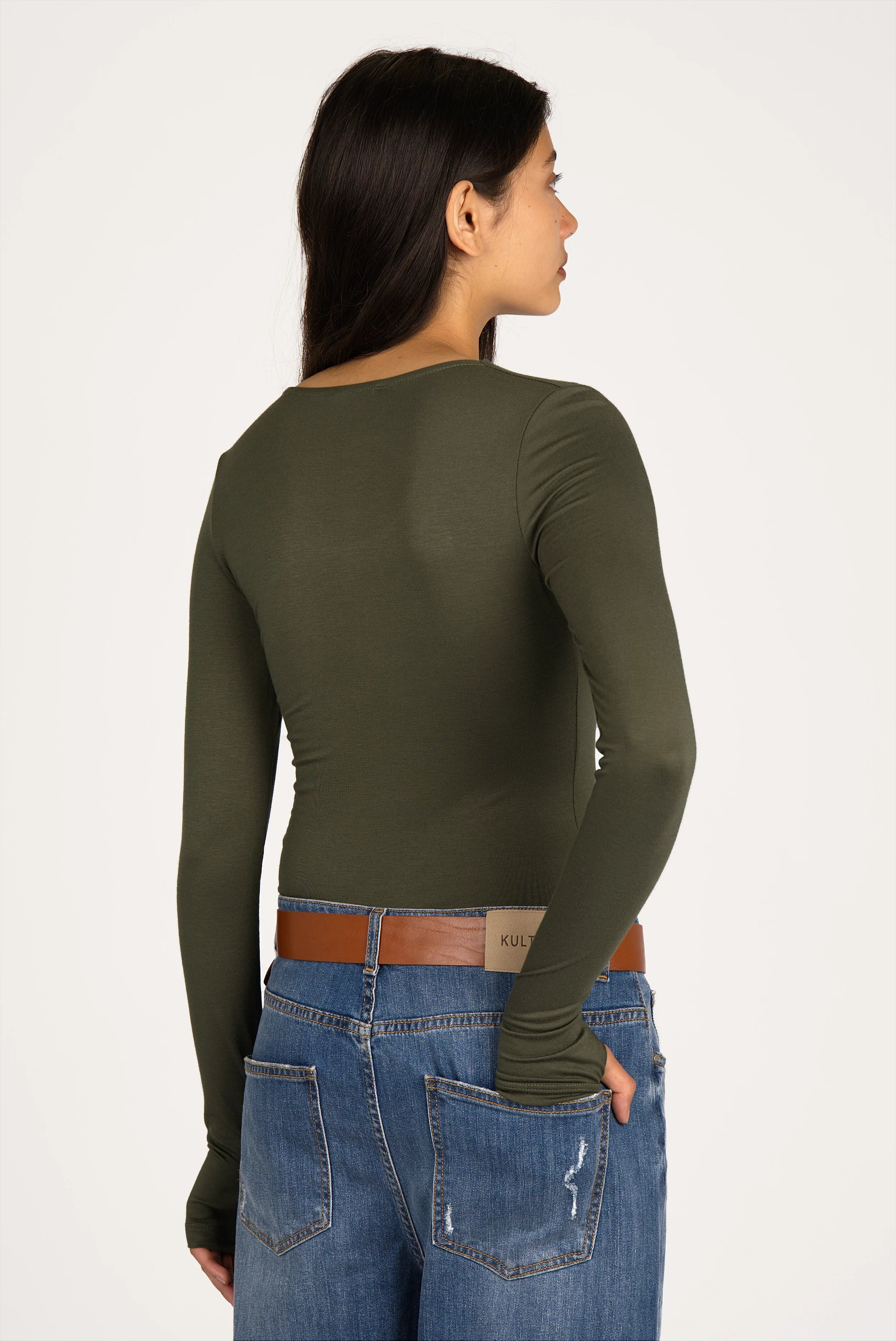Woman wearing olive green VALUM Longsleeve with U-boat neckline, extra-long sleeves, and thumb holes viewed from the back.