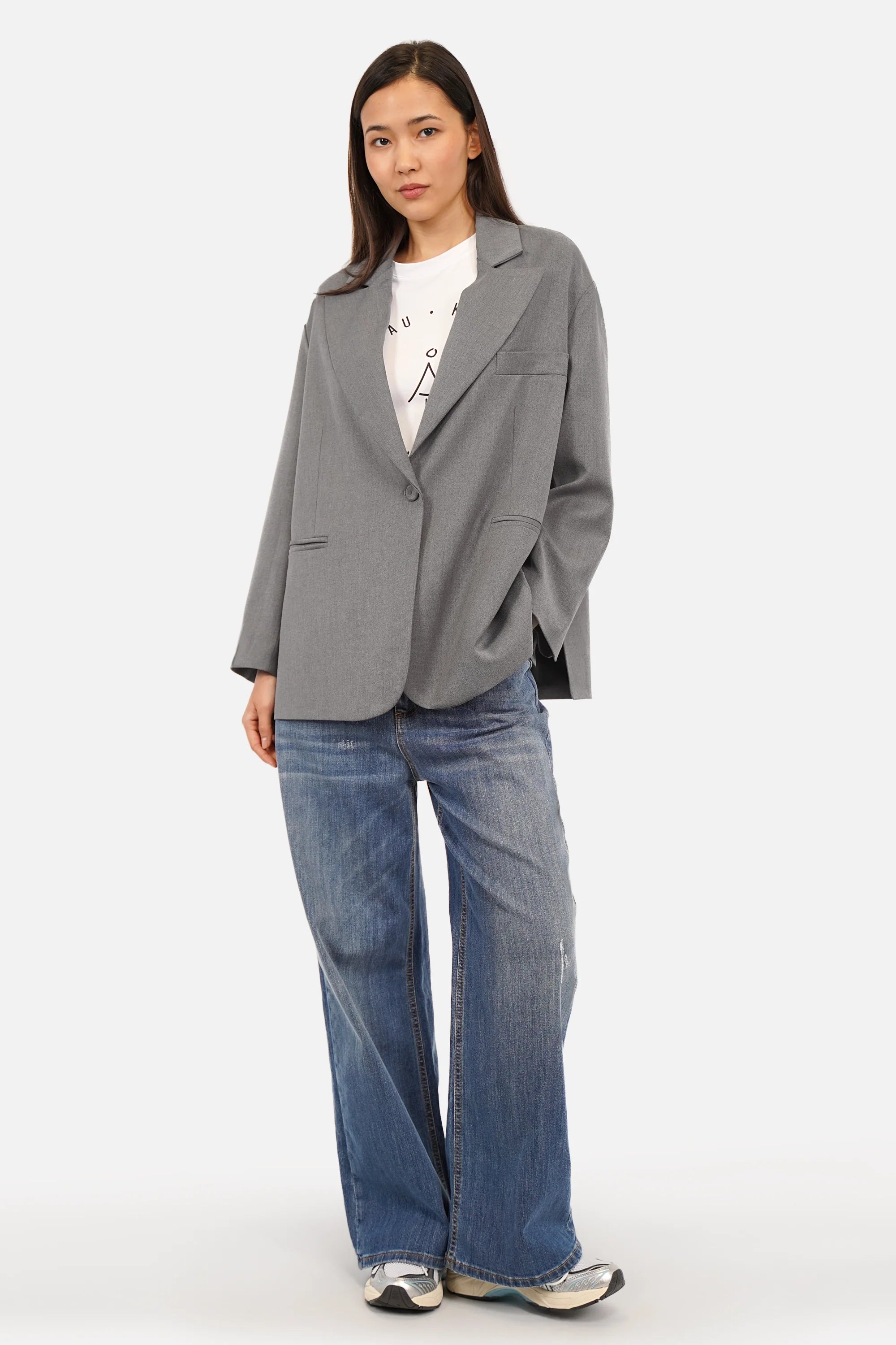 Oversized blazer with soft flowing fabric, notch lapel, fabric-covered button closure, welt pockets, back vents, and lining.