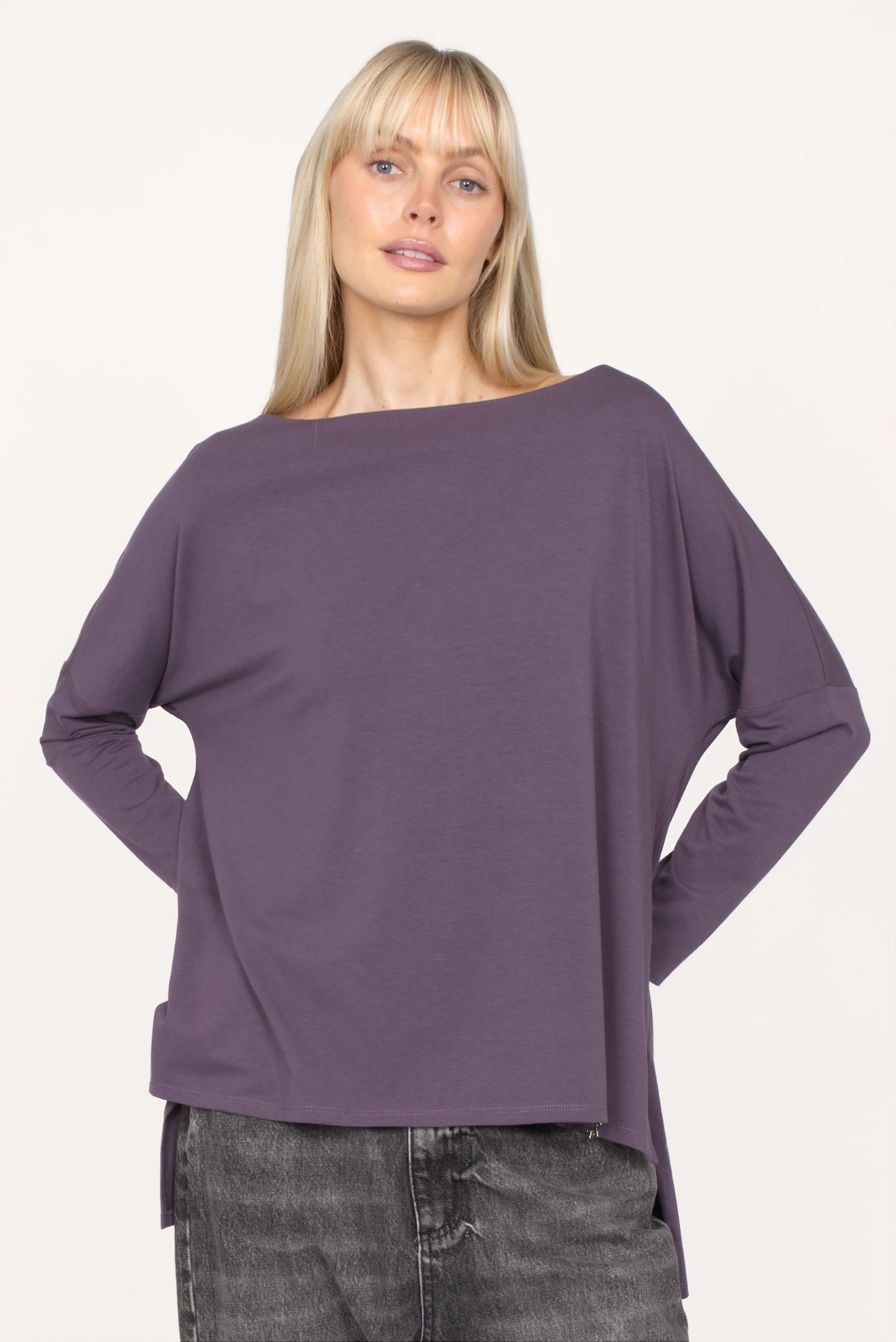 AMALEA Relaxed Fit purple long sleeve shirt with boat neckline, dropped shoulders, side slits, and extended back hem on model