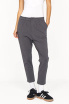 Dunkelgraue HEELENA OG Tapered Pants mit schmal zulaufendem Bein und verkürzter Länge, getragen mit Sneakern.