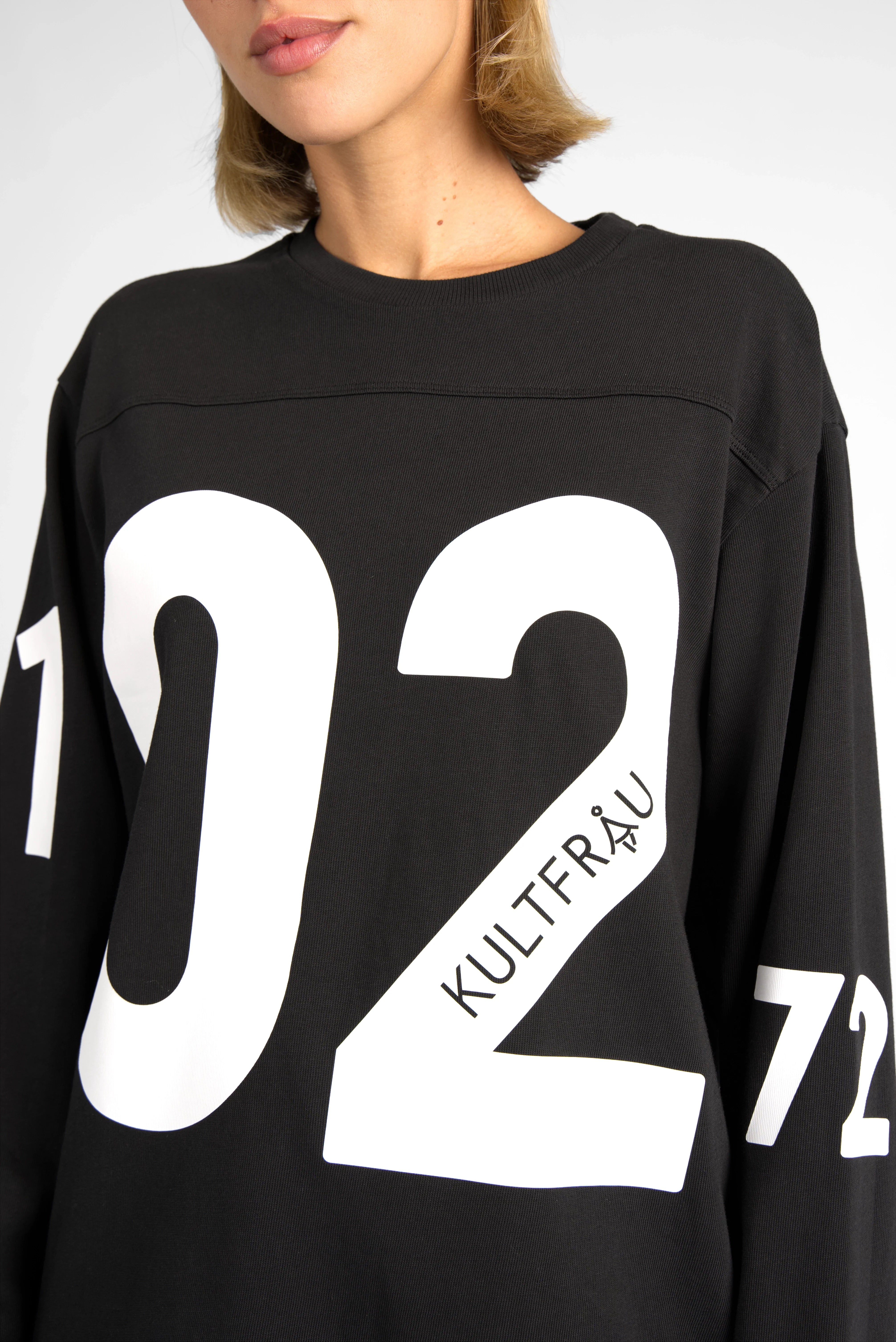 Black AGA Statement Sweater with oversized white number print on chest and sleeves, round neck, regular fit cotton jersey.