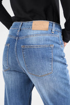 Close-up of ALVA Boyfriend-Jeans in mid-wash blue with raw-cut rolled cuffs and back pockets