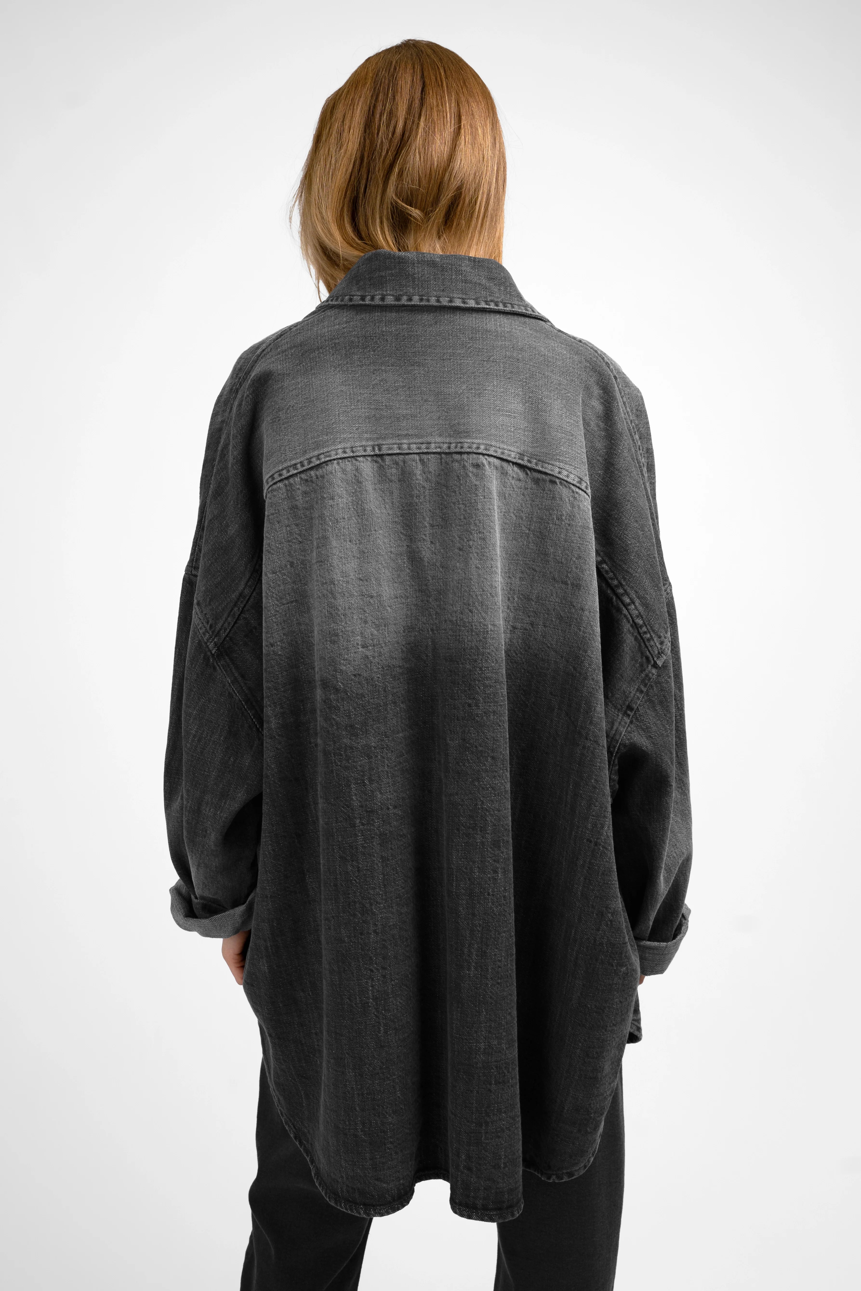Back view of ANEA Oversized Hemdjacke in gradient washed black denim look with relaxed fit and shirt collar