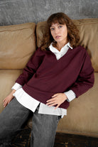 Damen trägt BERLEY Relaxed V-Neck Bluse aus kompaktem, weichem Jersey mit V-Ausschnitt und relaxed Fit